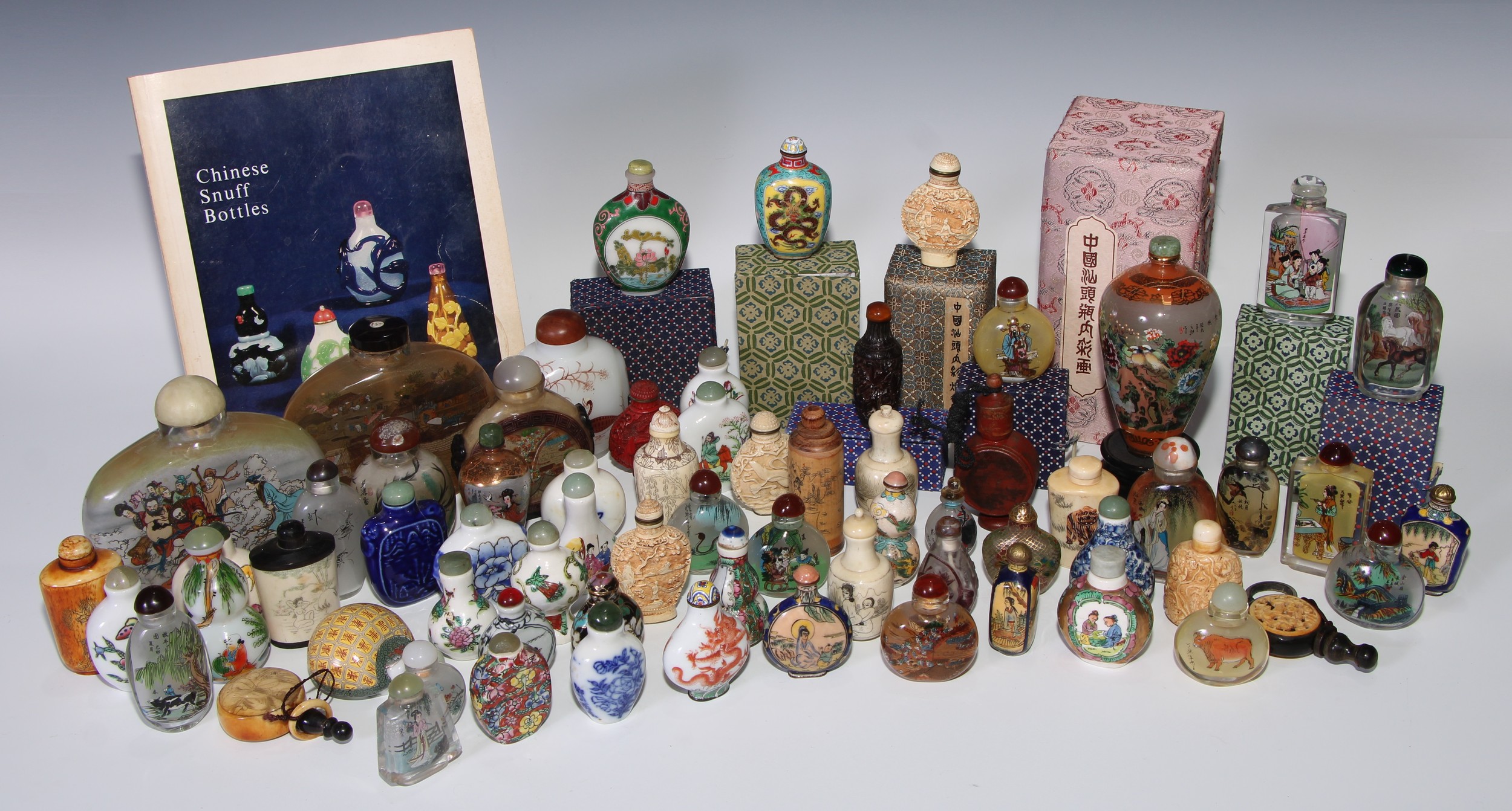 An extensive collection of Chinese snuff bottles, various forms and types of decoration, including inside painted, porcelain, bone and cinnabar lacquer examples, the largest 13cm high, the smallest 6cm high (qty)