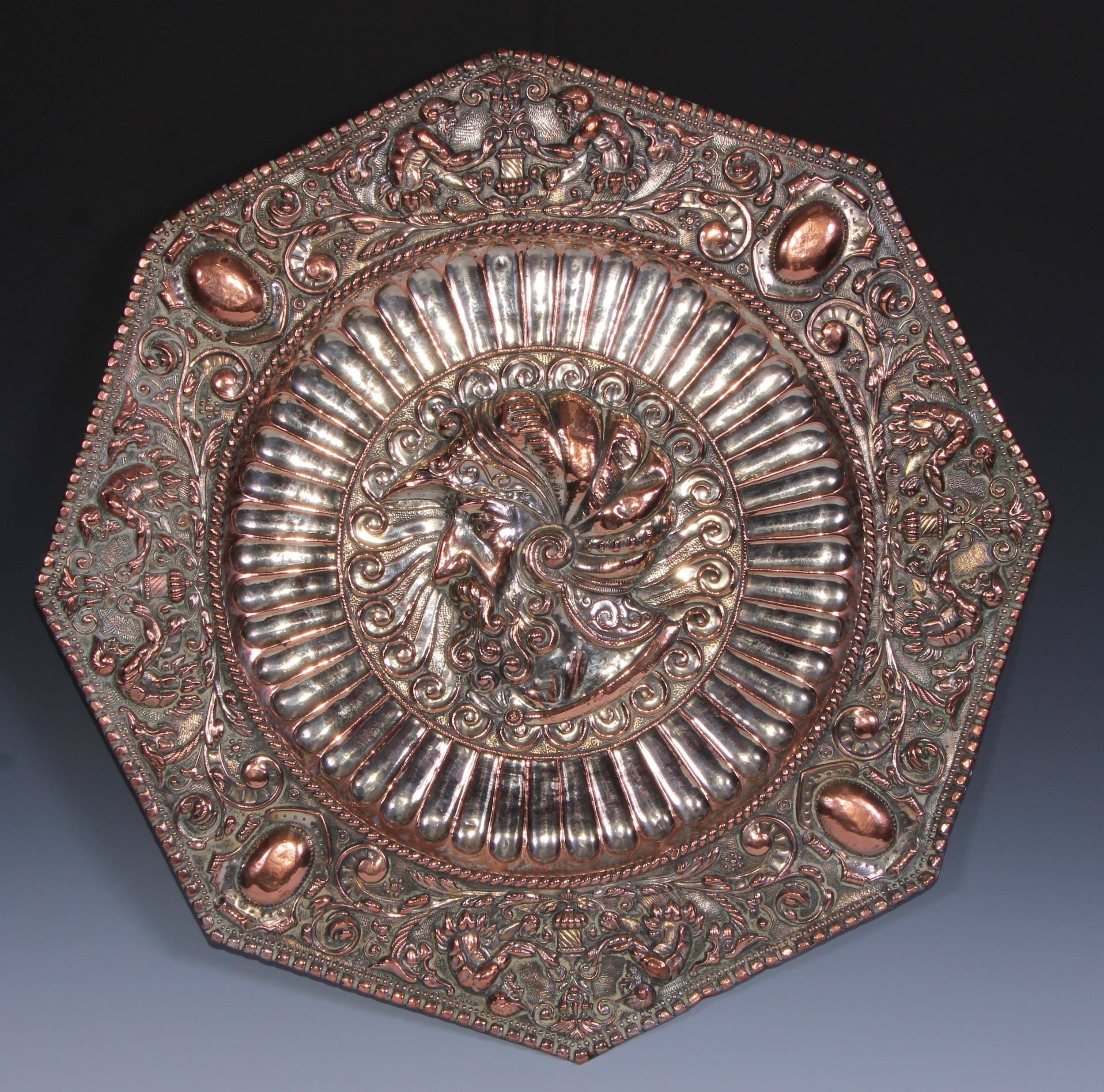 A 19th century Historicist Revival silvered copper octagonal charger, repousse chased with a profile portrait bust of a knight, the border with Renaissance motifs, 54cm wide, c.1880