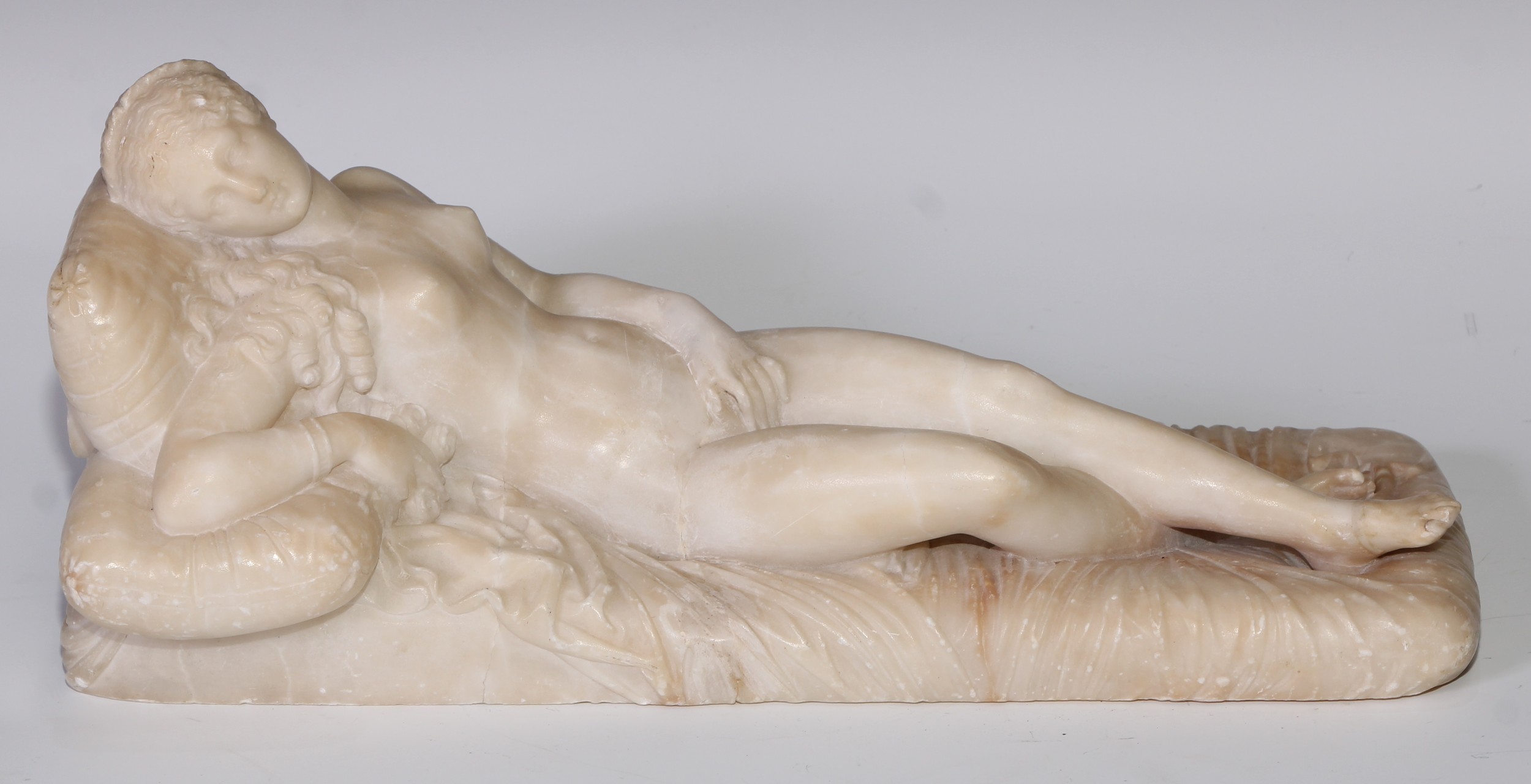 After Lorenzo Bartolini (1777–1850), an alabaster, Reclining Venus, the composition inspired by Titian, 33cm long