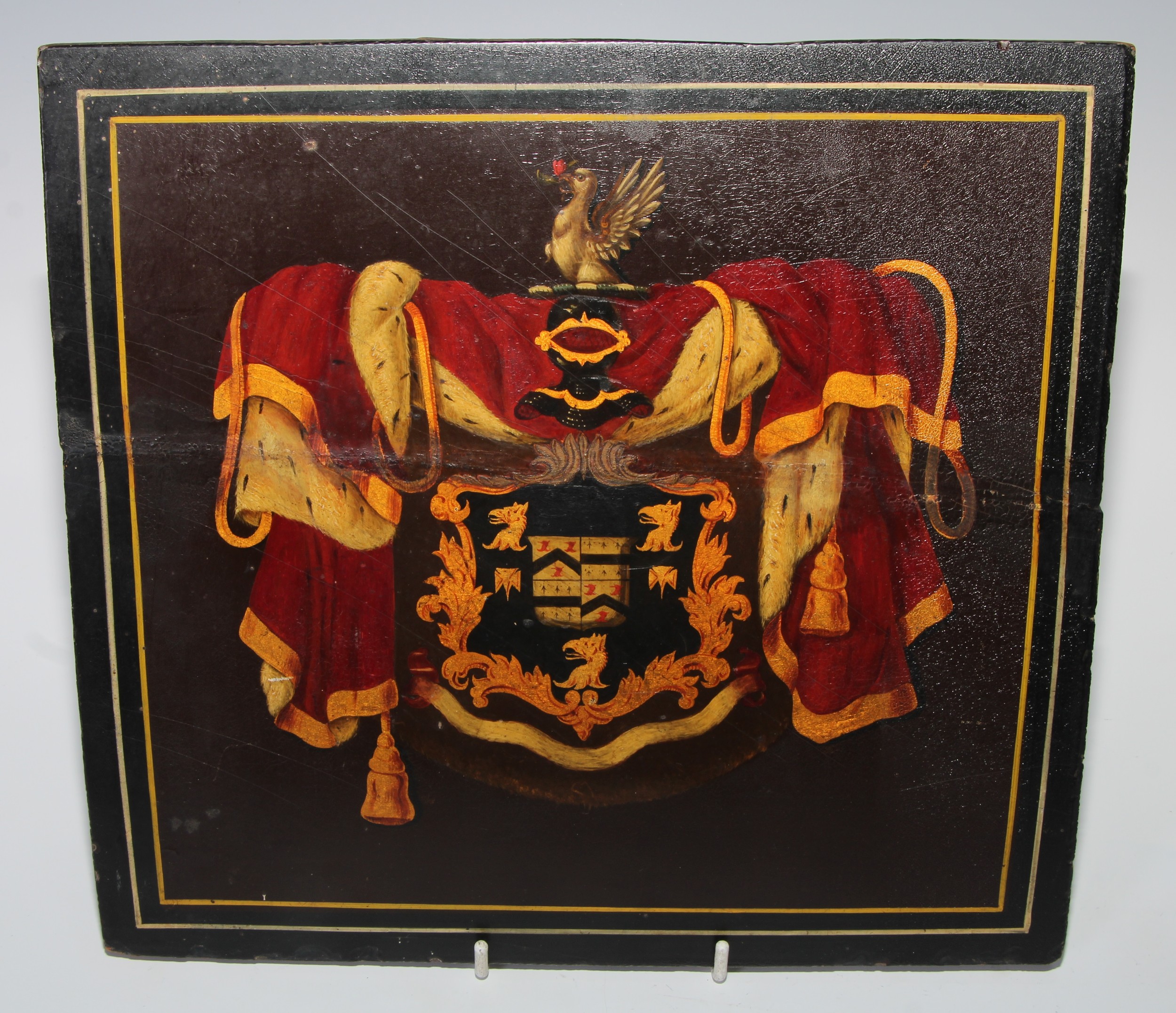 Heraldry - a 19th century armorial coach panel, painted in polychrome picked out in gilt, 26.5cm x 28cm