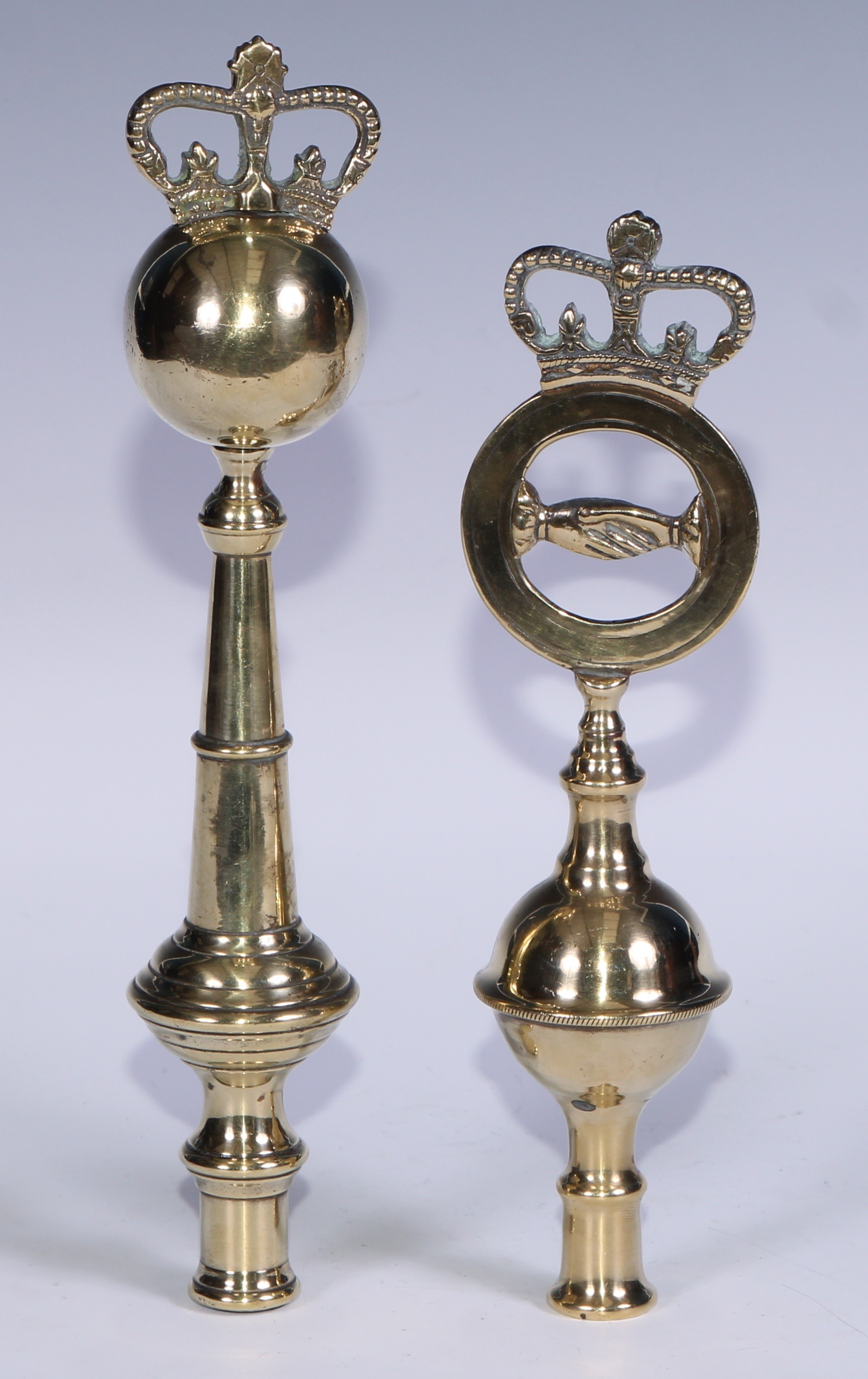 Masonic/Friendly Society Interest - a 19th century West Country brass friendly society pole head, cast with an orb surmounted by a crown, 24cm high; another, with clasped hands and crown, 20.5cm high (2)