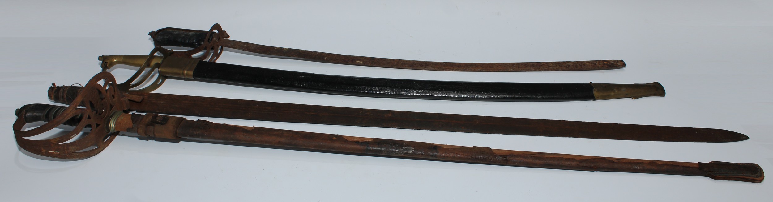 A George V rifle regiment officer's sword, 84cm straight fullered blade with GRV cipher, steel hilt with crowned bugle, shagreen grip, partial scabbard102cm long overall; a Sudanese kaskara blade; etc (4)