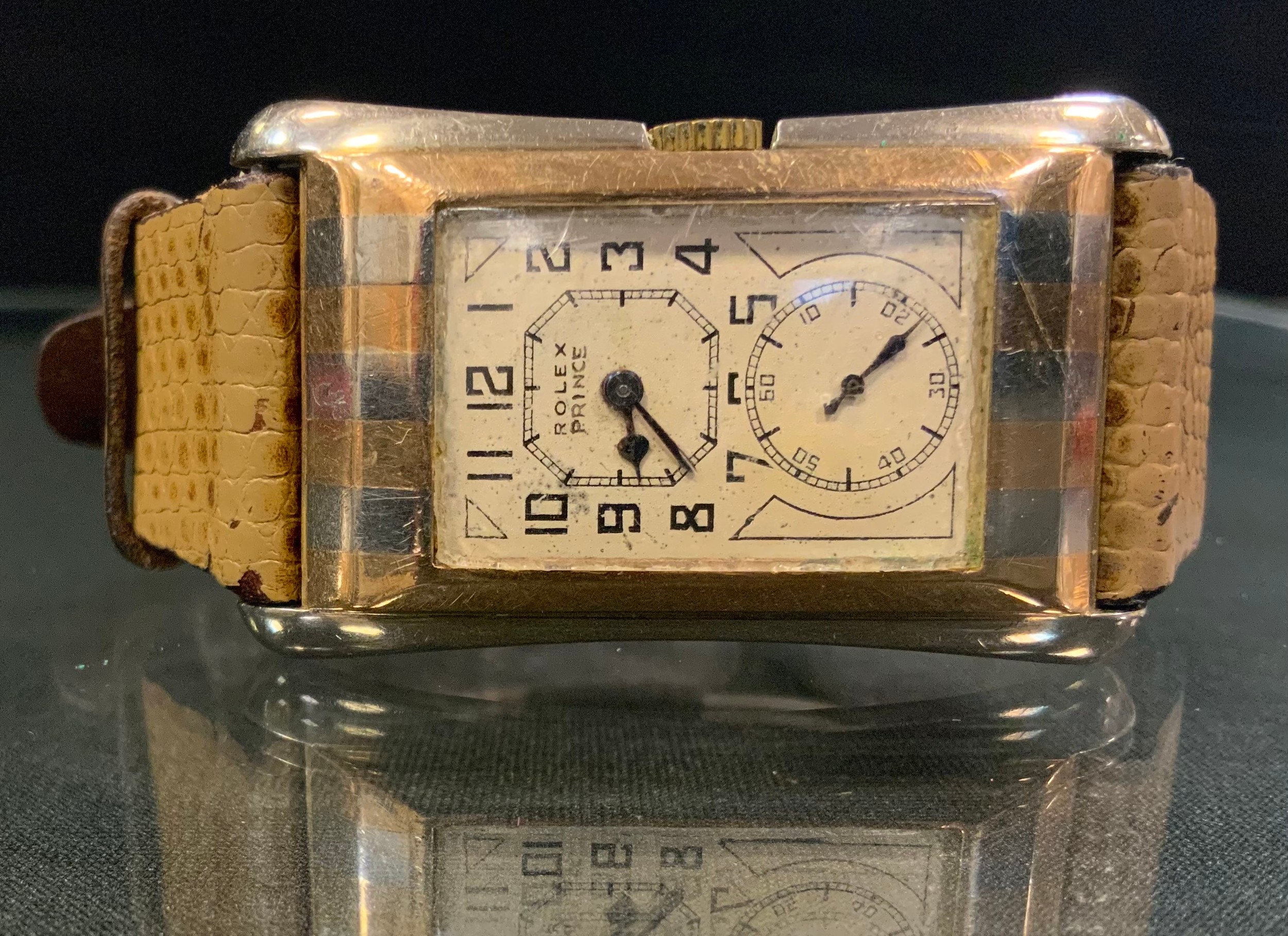 Rolex - a Gentleman's Rolex Prince Brancard wristwatch, rectangular dial signed Rolex Prince, higher dial with Arabic numerals, blued steel hands, lower dial indicates seconds, rectangular flared case 43mm by 26mm with curved profile and alternate white and yellow "Zebra" stripes, snap on case back internally marked Rolex 25 World's Records, Geneva-Suisse  'R.W.C.Ltd' 9ct gold case, import marks Glasgow 1929, manual wind movement signed 'Rolex Hairspring Timed 6 Positions Observatory Quality 15 Rubies' and signed 'Rolex Extra Prima' to the barrel, movement serial number 71889, model number 971A, serial number 68283, fitted with a later snakeskin effect strap, 32.4g gross