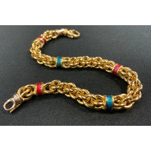 An 18ct gold fancy link bracelet divided by five alternate enamelled bands in emerald green and ruby red, stamped 750, indistinct marks, 20.5cm long, 23.5g gross
