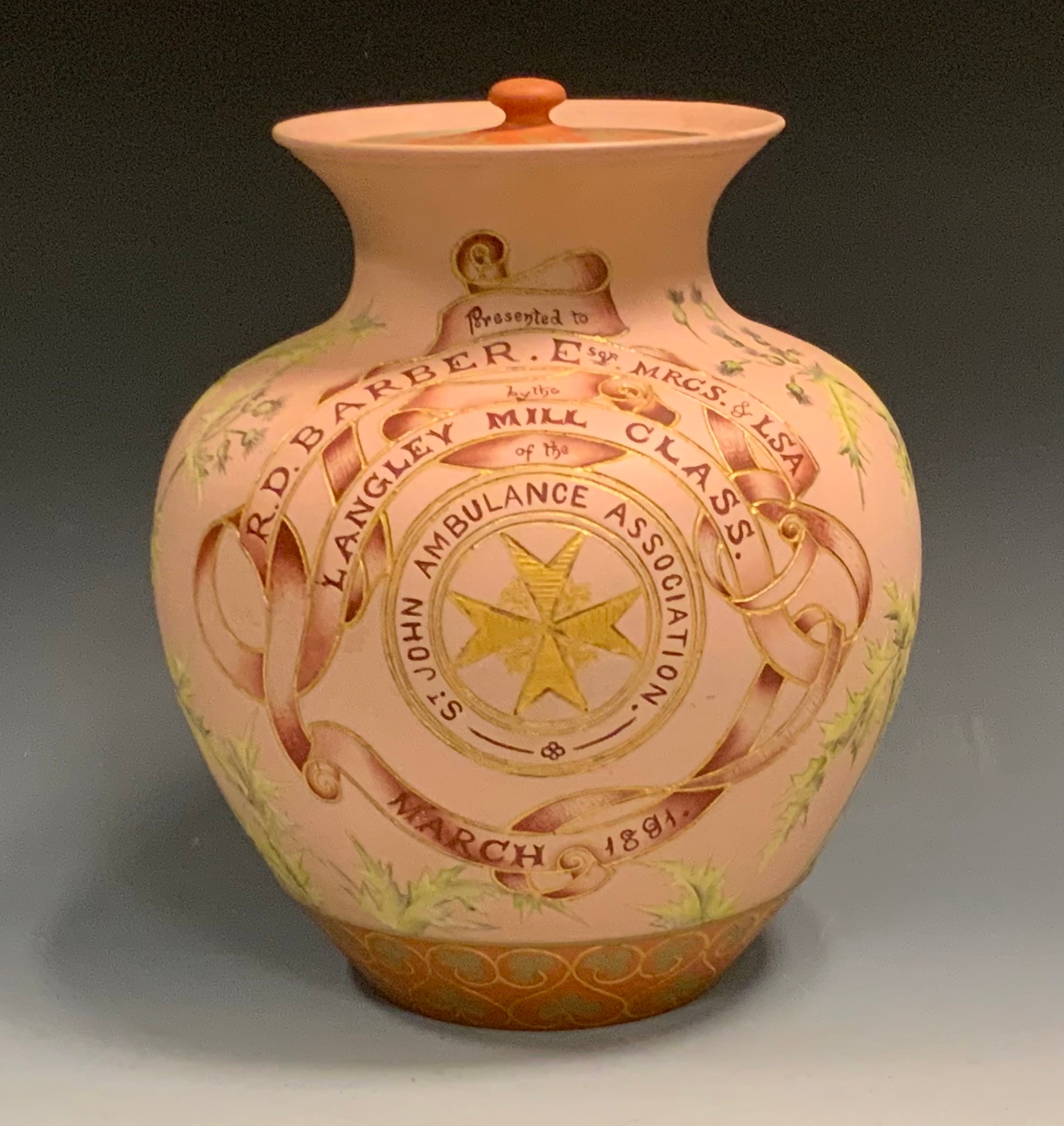 A Langley Ware vase and cover, designed by Mary Helen Goodyer, incised throughout with flowers and foliage, 'Presented to R.D.Barber Esqr MRCS & LSA, by the Langley Mill Class of the St John Ambulance Association, March 1891', 26cm high, monogrammed
