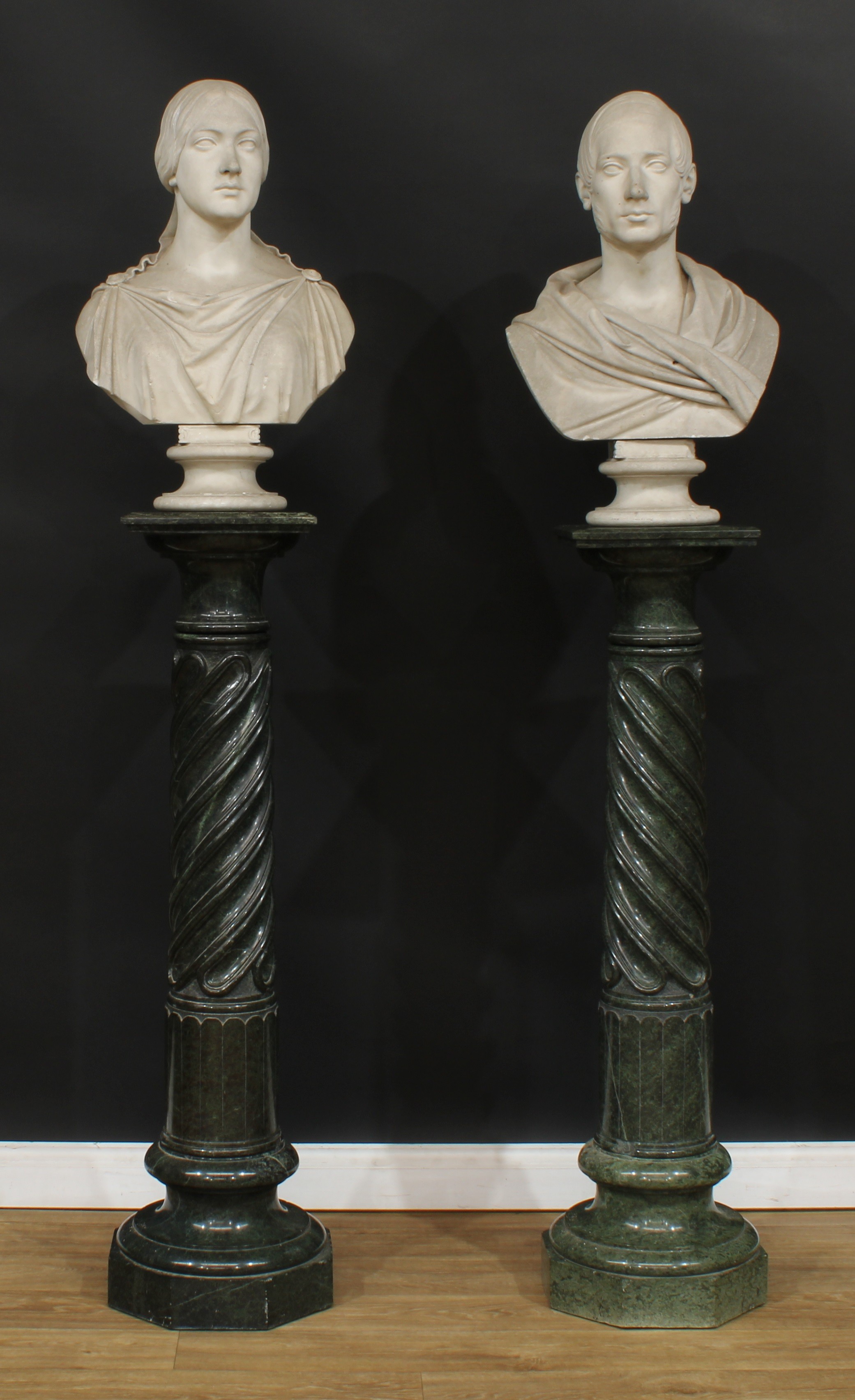 A pair of 19th century Neoclassical serpentine statuary pedestals, each with a near-square top above a spirally fluted column, waisted socle, octagonal base, the largest 125.5cm high, the top 29.5cm x 29cm, the other 123cm high, the top 29cm x 28.5cm