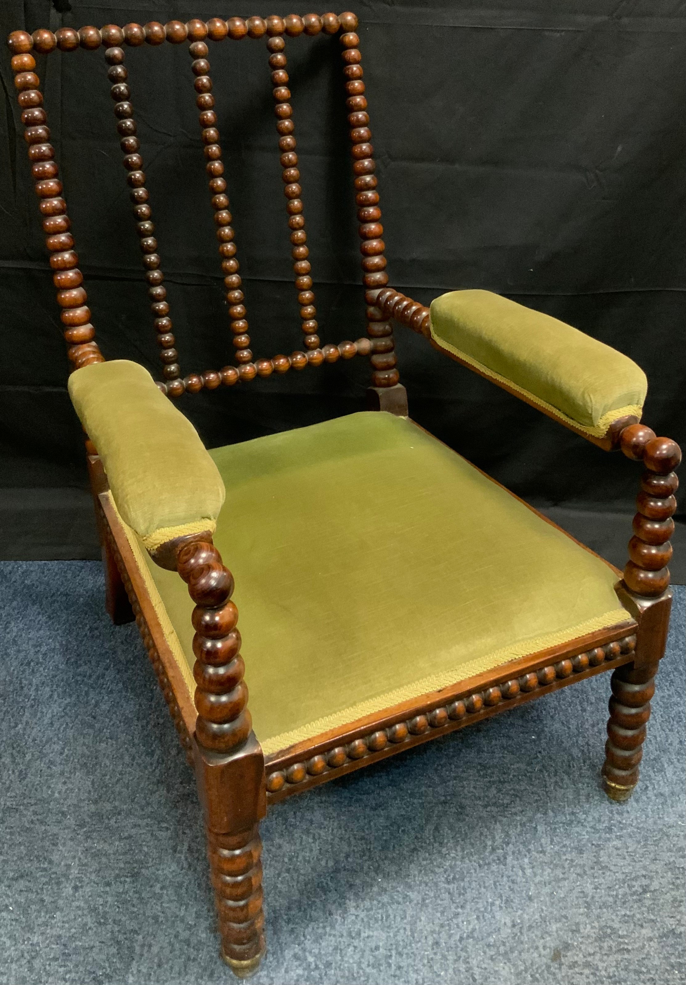 A 19th century rosewood bobbin turned side chair, stuffed over seat and arm rests, c.1840