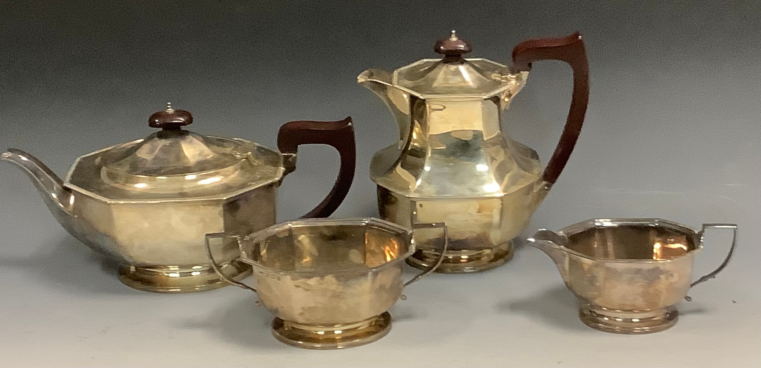 A silver four piece panelled boat shaped tea service, gadrooned border, hotwater jug 20cm high, Collingwood & Sons Ltd, Birmingham 1933, 1661g, 53.5ozt