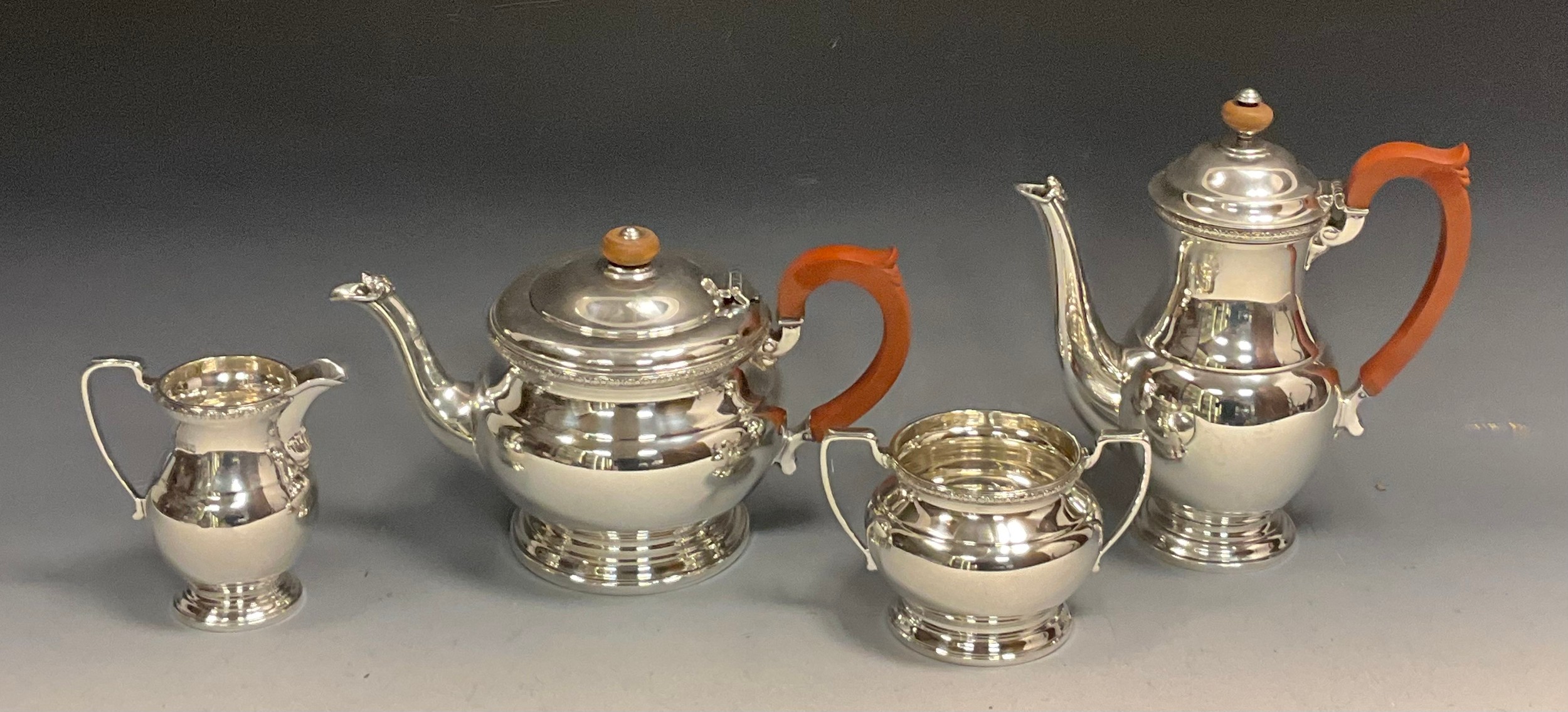 A mid 20th century silver four piece tea set, teapot, hot water jug, sugar bowl and milk jug, Elkington & Co, Birmingham 1966-67, 53ozt gross