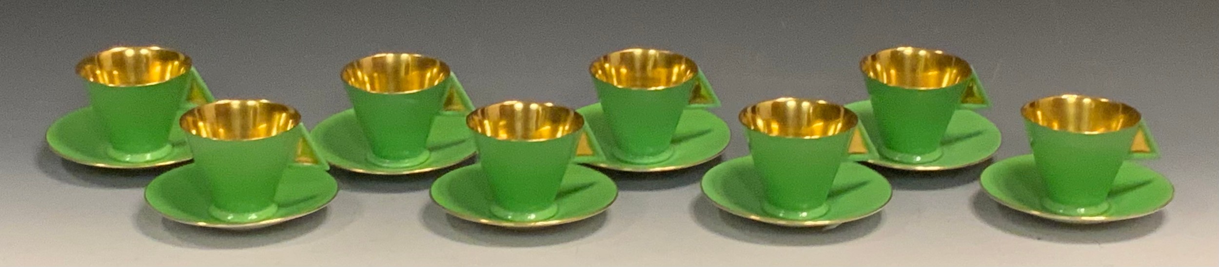 A set of eight Shelley Pottery Vogue coffee cups and  saucers, gold interior, lime green exterior, printed marks, pattern no.11754  Literature Andrew Casey Art Deco Ceramics in Britain ACC page 81 plate 11.3 for a comparable trio
