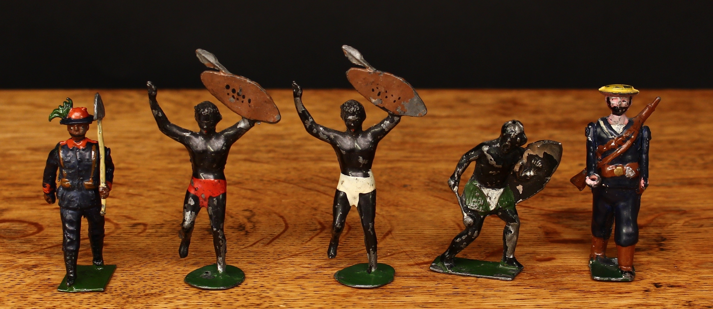 Reka (C W Baker) group of figures, comprising a Zulu figure with shield and knobkerrie, two African warrior figures, a sailor with straw hat and two movable arms and an Italian Bersagliere with shovel, each unboxed (5)  For similar examples see Joplin, The Great Book of Hollow-Cast Figures (New Cavendish Books) ISBN-1-872727-78-6 pages 195 and 196.