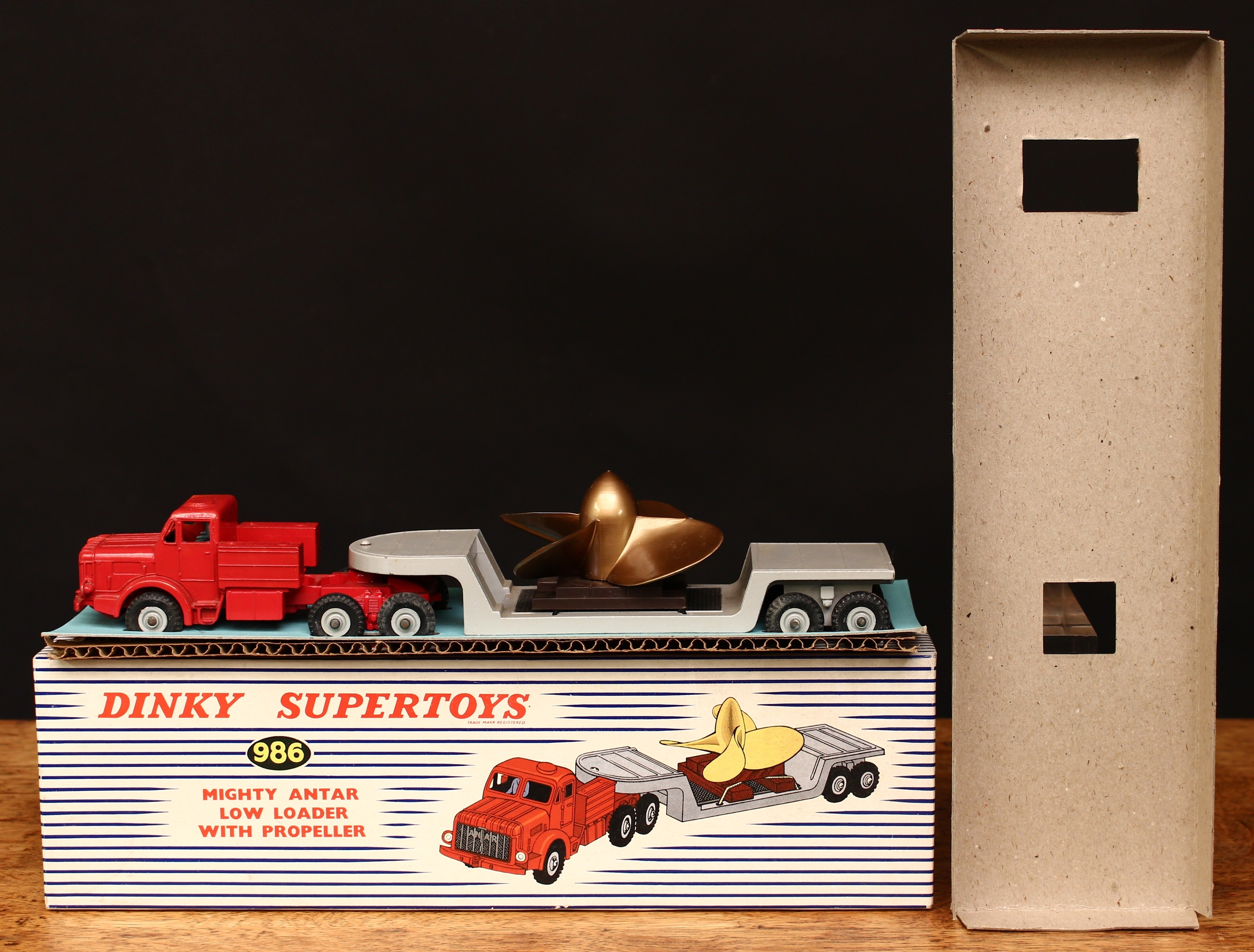 Dinky Supertoys 986 Mighty Antar low loader with propeller, red cab with pale blue painted seated driver figure, grey low loader with bronze propeller, grey hubs, boxed with original inner cardboard packaging pieces - blue and white striped picture box