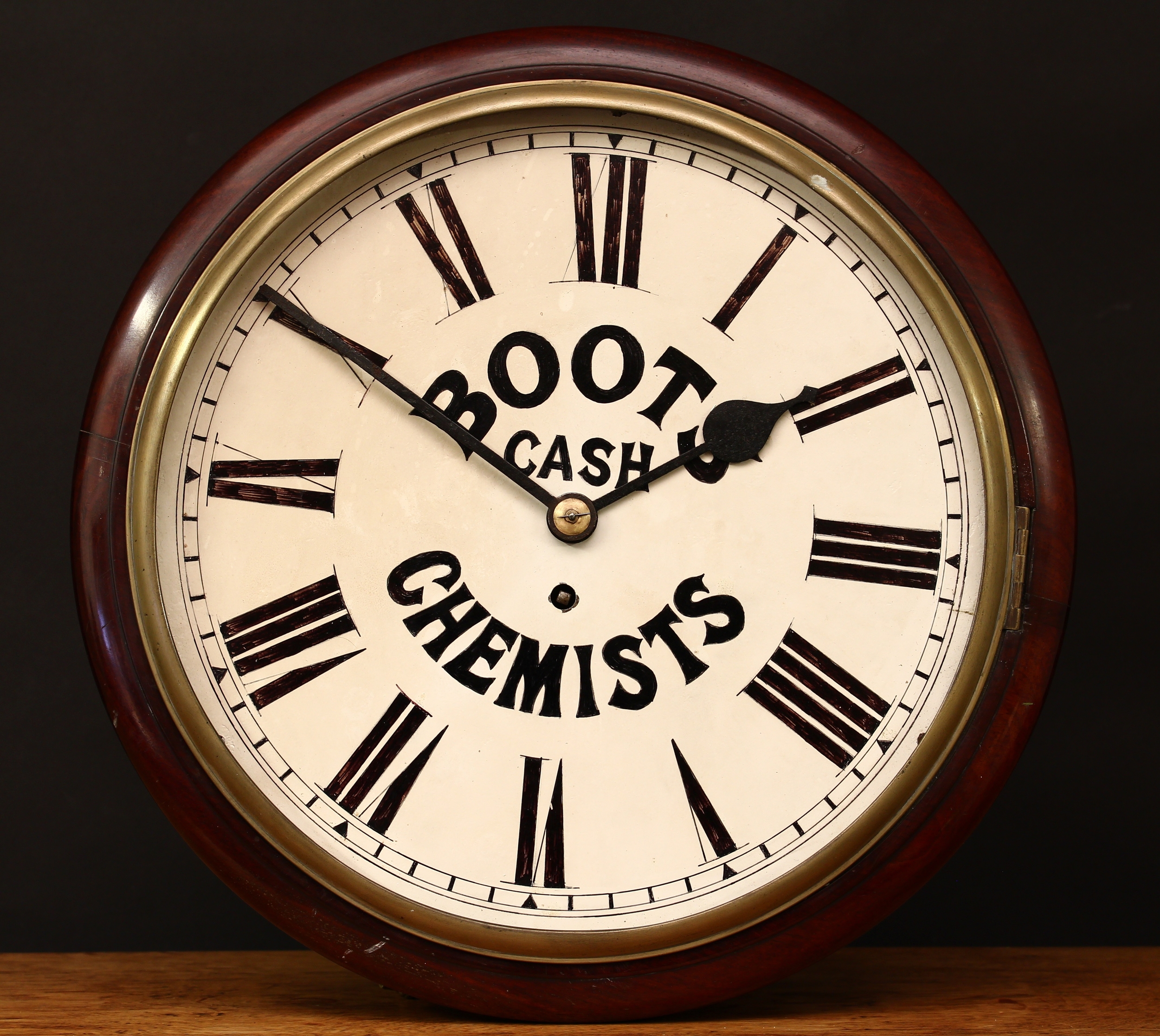 A Victorian mahogany circular wall clock, 'BOOTS CASH CHEMISTS'