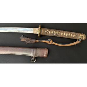WW2 Imperial Japanese Officers Shin Gunto Katana Sword. Single edged 660mm long blade. Tang is signed Noshu ju Takeyama Yoshinao Kin Saku . Overall length mm. Complete with Company Grade Officers Knot and leather covered active service scabbard. War Souvenir of British Lt. Col Charles Frederick Seston MBE, RIASC.