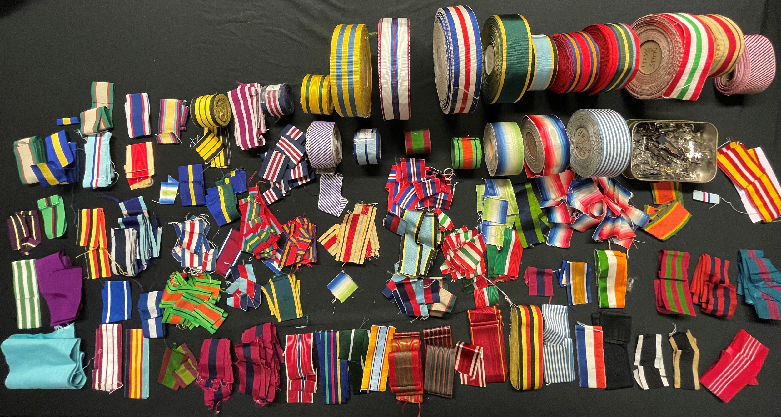 British Medal Ribbons. Original, new old stock ribbons. A large quantity of ribbons all original no modern reproductions. Ribbons date from pre WW1 through WW2 and up to the 1990's. Some of the WW2 ribbons on reels are dated 1945. Also some foreign ribbons such as Russian St Anne, French Croix de Guerre, US Bronze Star. Plus a tin full of ribbon emblems, MiD Oakleaves, Rosesettes etc.