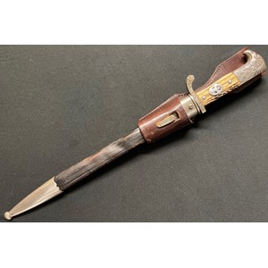 WW2 Third Reich Gendarmerie Police Side Arm. Single edged fullered blade 330mm in length, maker marked "Paul Weyersberg & Co, Solingen". Stag horn grip fitted with Police Eagle. No markings to crossguard. Stylised eagle's head pommel. Overall length 450mm. Complete with brown leather scabbard. Together with brown Police leather frog