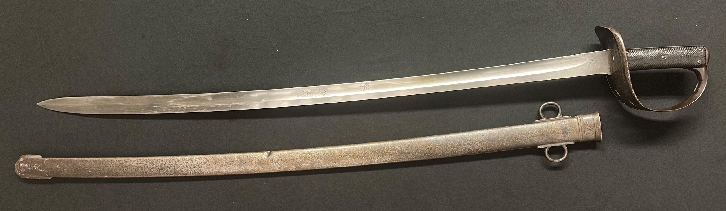 British 1885 Pattern cavalry trooper's sword with single edged fullered blade 870mm in length, maker marked "Weyersberg, Kirschbaum & Cie, Solingen" dated 3/92 along with many inspection marks. Overall length 101cm. Complete with scabbard with date 6/1892 plus unit markings of "Y Ntt 50".