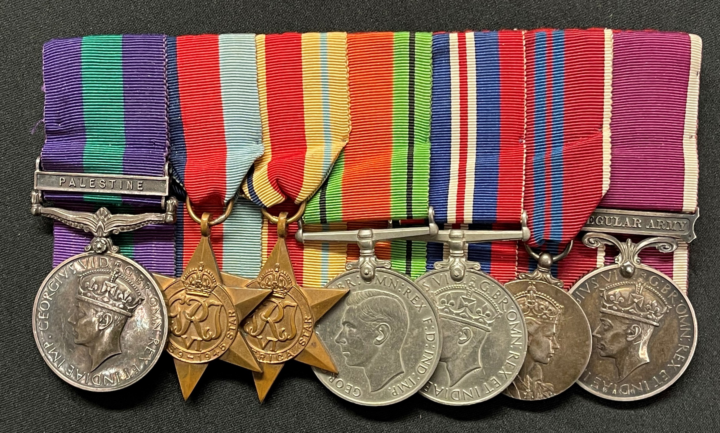 WW2 British Coldstream Guards Guards Prisoner of War Medal group to 5932020 Clp. G Keen, Coldstream Guards comprising of GR VI General Service Medal with Palestine Clasp, 1939-45 Star, Africa Star, Defence Medal, War Medal, ERII Coronation Medal, Long Service and Good Conduct Medal. All court mounted on a bar with original ribbons. Plus his German PoW Dog Tag from Stalag IVB with original neck cord.