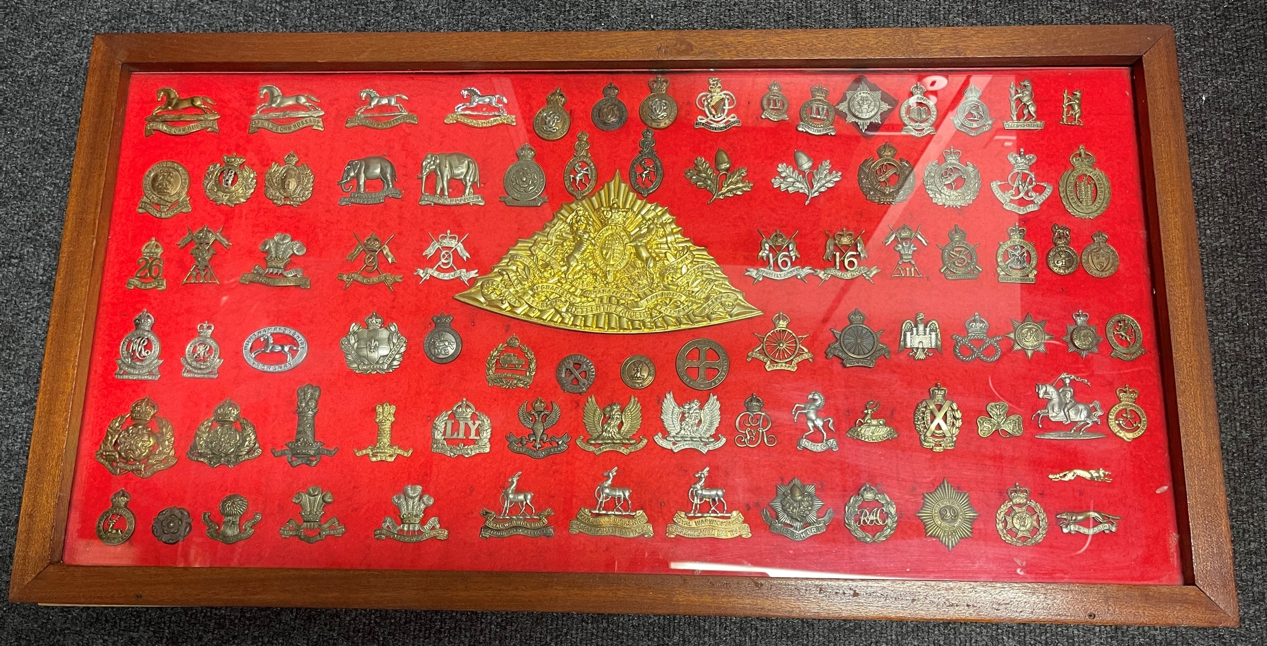 Framed collection of British Cap Badges. Mainly Cavalry / Yeomanry themed badges. Over 85 badges in total. To include 3rd Kings Own Hussars x 3, Queens Own Hussars x3, Queens Royal Hussars, IV Queens Own Hussars,  North Humberland Hussars, Royal Bucks Hussars, 14th Kings Hussars, 19th POW Hussars, Yorkshire Dragoons, South Notts Hussars x 2, Queens Own Oxfordshire Hussars, 9th Lancers, MTC, FANY, Army Cyclists Corps x2, RAC, Royal Warwicks, Cheshires, North Hants Yeomanry, etc. 16th Lancers Shako Plate.