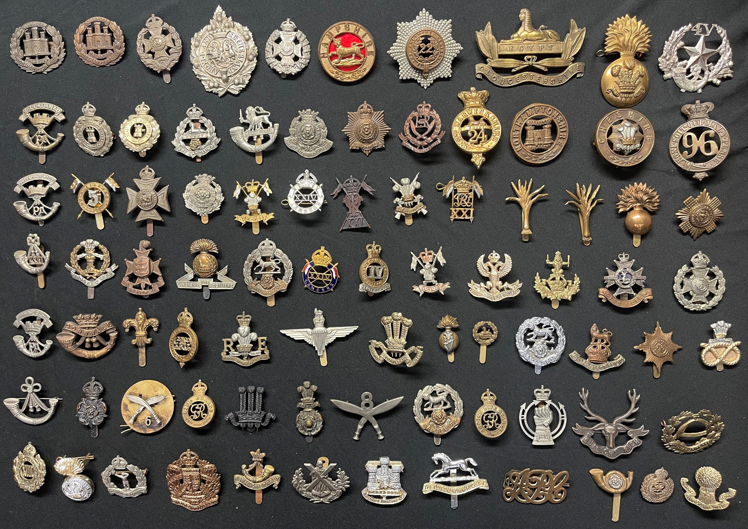 A collection of approx. 80 British cap badges to include: Northants Regt, West Yorks, Argyll & Sutherland Highlanders, Rifle Brigade, 22 Cheshire Regt, Cameronians, Isle of Wight Regt x 2, East Lancs, 3rd Vol Bn Hampshires, Hampshire Regt, RMP, 5th Lancers, Duke of Connaught's Own, IX-XII Lancers, XXIV Lancers, XXI Lancers Officers Bronze, Carabiners, XXI Lancers, Welsh Guards x 2, Grenadier Guards, Scots Guards, Middlesex Regt, Lancs Fusiliers, Royal Hampshires, XXIV Lancers enamelled, Queens Own Hussars, Lanarkshire Yeomanry, Notts & Derbys, Robin Hoods, RAC, Second Life Guards, 8th Gurkhas, 6th Gurkha Rifles, Duke of Cornwall's Light Infantry, KSLI, Royal Observer Corps, QC Parachute Regt, etc. Plus RE Sweetheart lapel badge and WW1 Army Pay Corps Shoulder title.