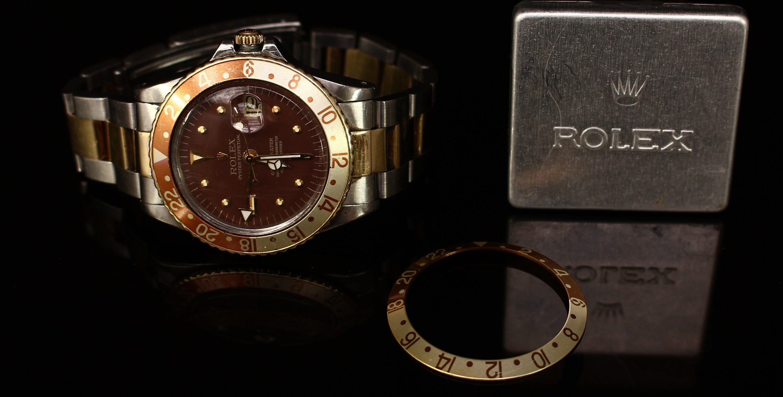 A Rolex Oyster Perpetual GMT-Master Superlative Chronometer, brown dial, baton indicators, date aperture, centre seconds hand, with spare bezel in a Rolex tin
