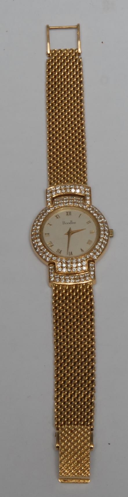A Boodles 18ct gold lady's wristwatch, the dial encrusted with pave set diamonds, Roman numerals, integral 18ct gold bracelet strap, marked 750, 61.33g, original box