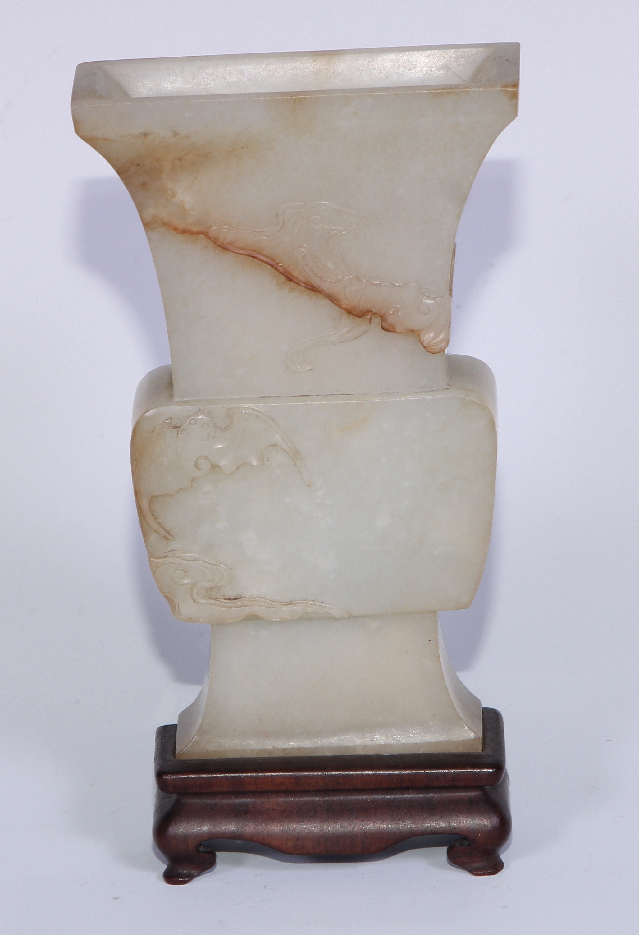 A Chinese flattened celedon pale jade archaic vase, carved with bats, 14cm high