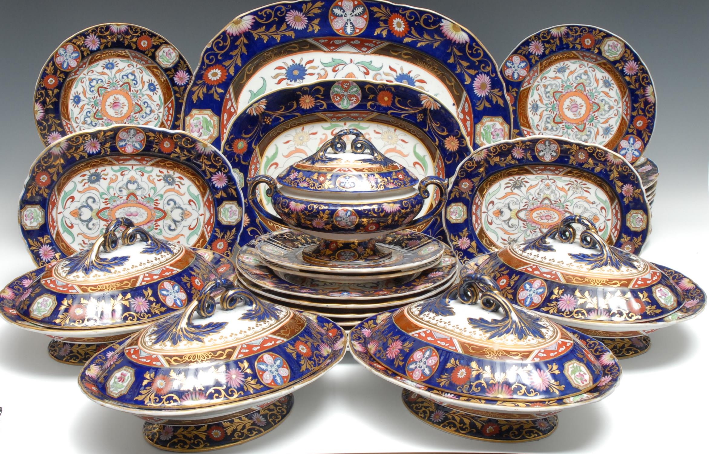 An extensive Ashworth Real Ironstone dinner service, comprising seven large plates, twenty-four smaller plates, four tureens and covers, graduated serving plates,  each decorated in polychrome and picked out in gilt on a cobalt blue ground, the largest meat plate 44cm wide, impressed and printed marks, c.1865