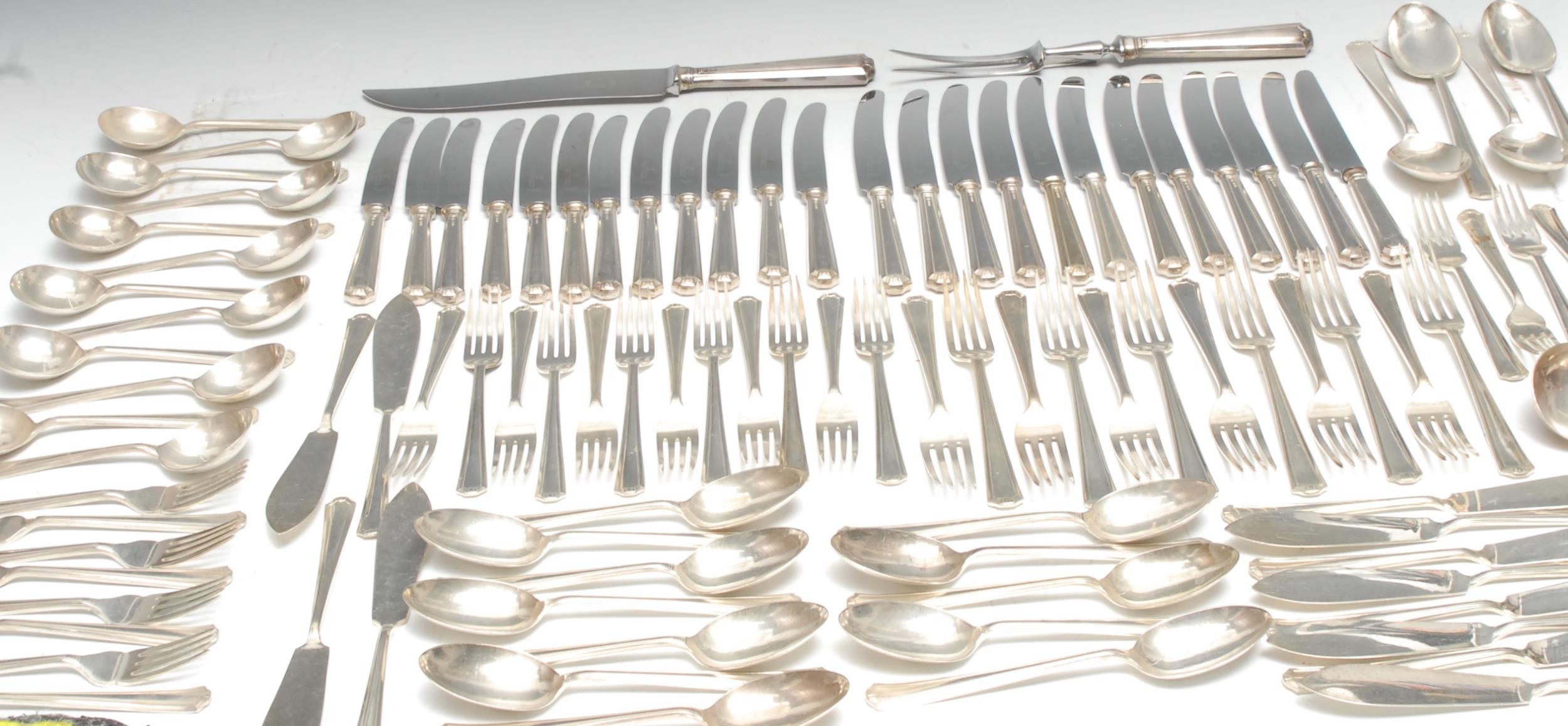 An Elizabeth II silver table service, for twelve, comprising table knives and forks, salad knives and forks, soup spoons,  dessert spoons, four table spoons, a soup ladle and pair of sauce ladles, Francis Howard, Sheffield 1972; a set of twelve silver fish knives and forks, Francis Howard 1973; a silver hafted carving set, Francis Howard, Sheffield 1965, total 146oz excluding loaded pieces