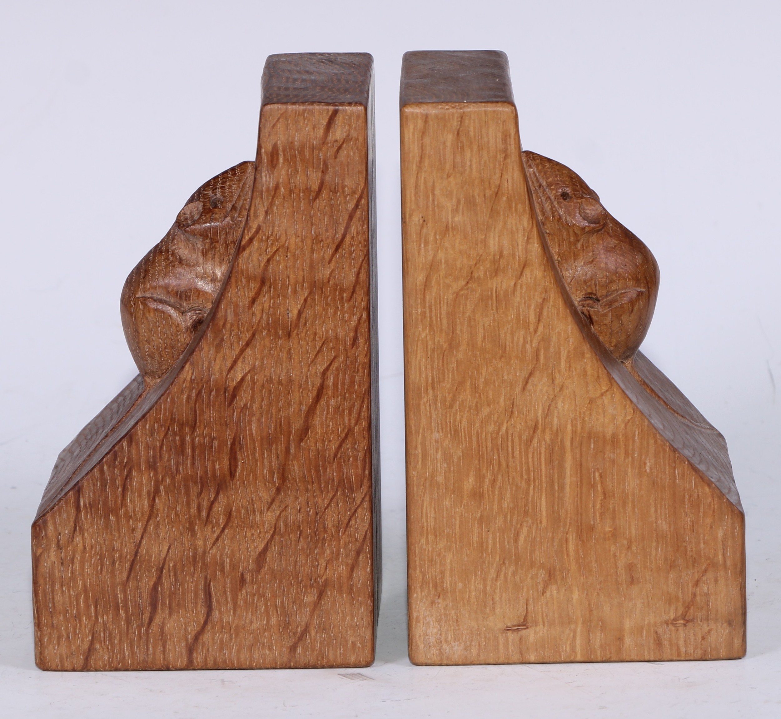 Mouseman of Kilburn - a pair of oak book ends, adzed overall, carved mouse signatures, 15.5cm high