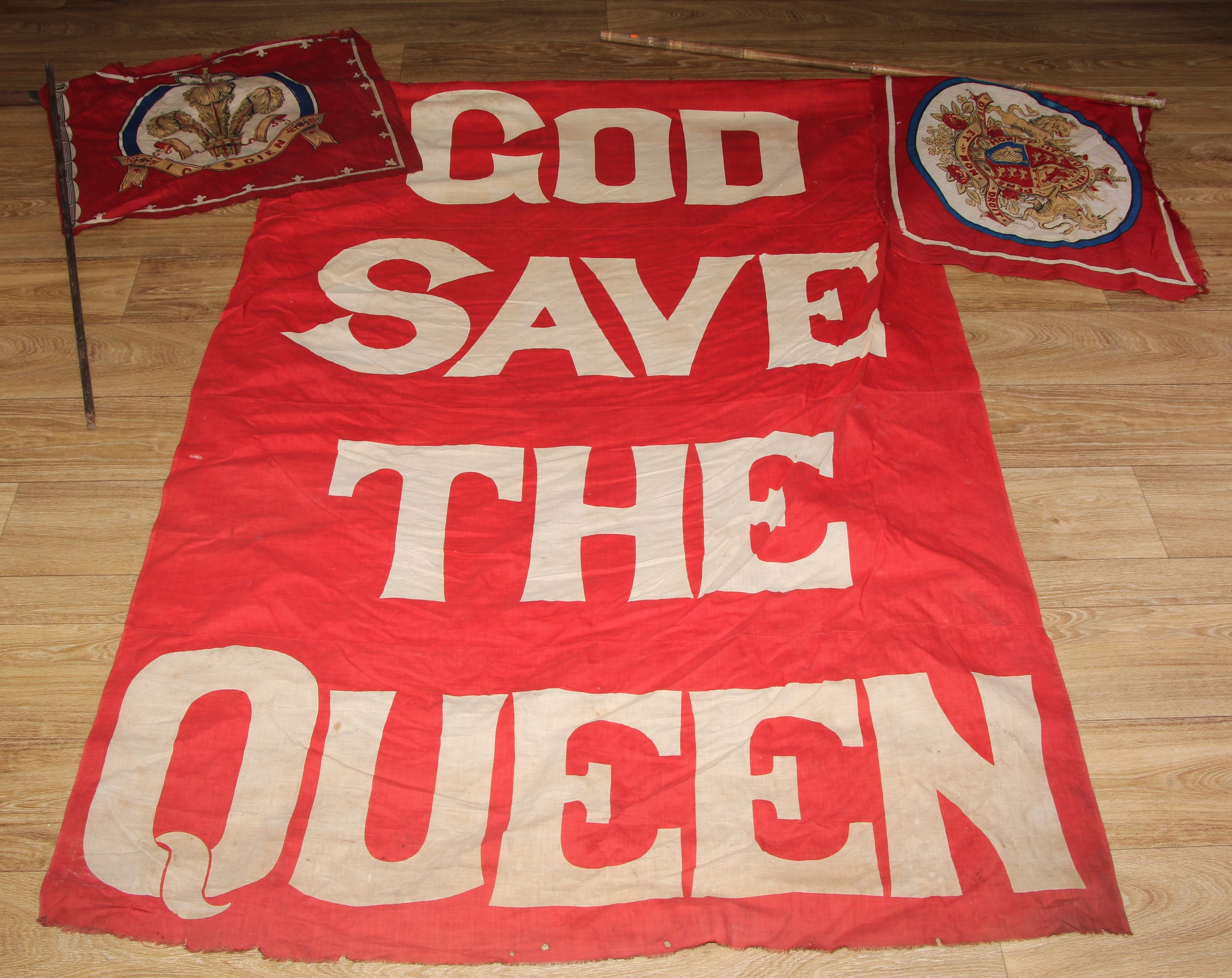 A large Victorian linen flag, God Save the Queen, 168cm x 112cm, the turned pine rail 189cm long, c. 1897 - 1901; others, royal coat of arms (3)