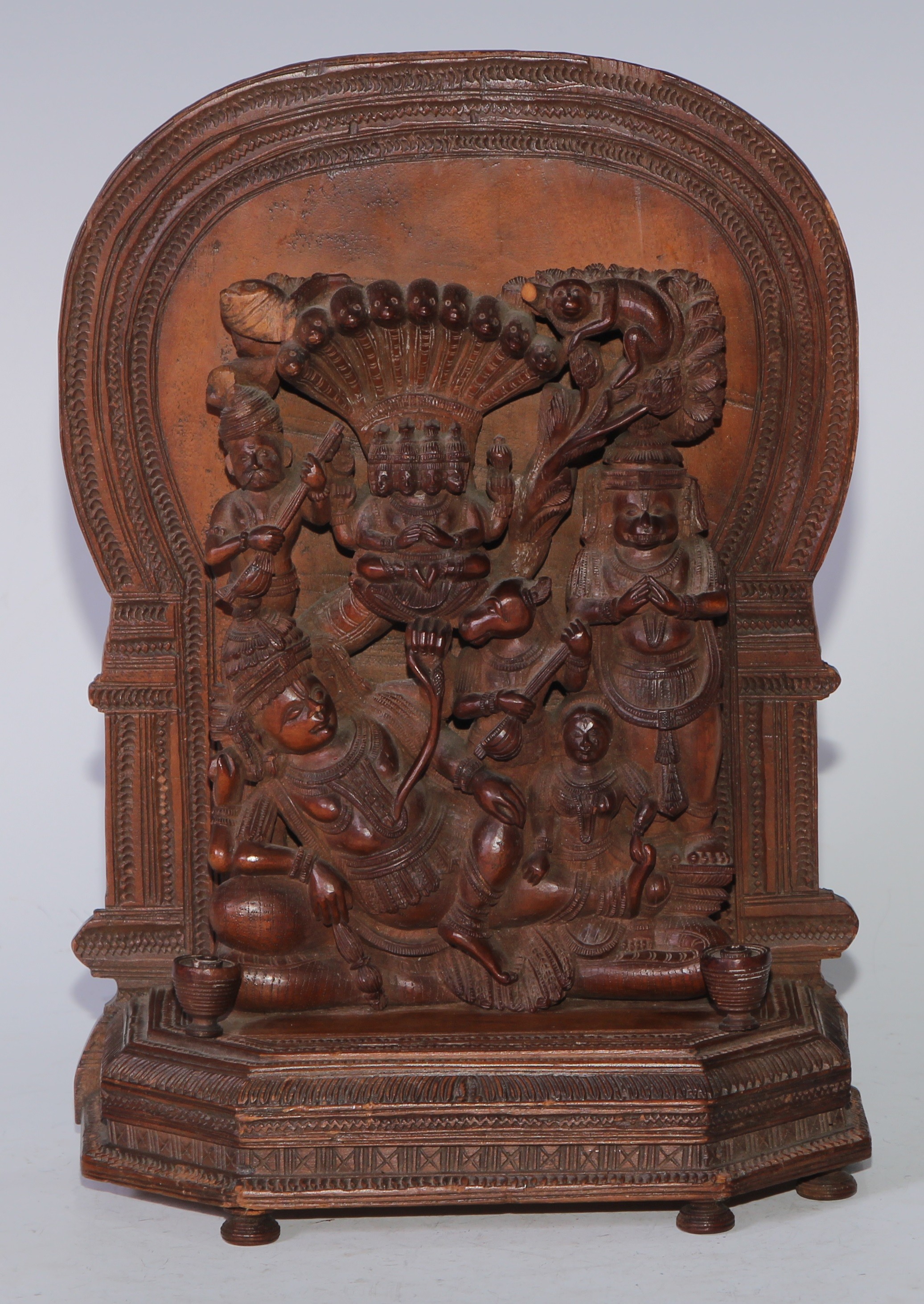 An Indian sandalwood votive shrine carving, arched back, 23cm high, 16cm wide, c.1900