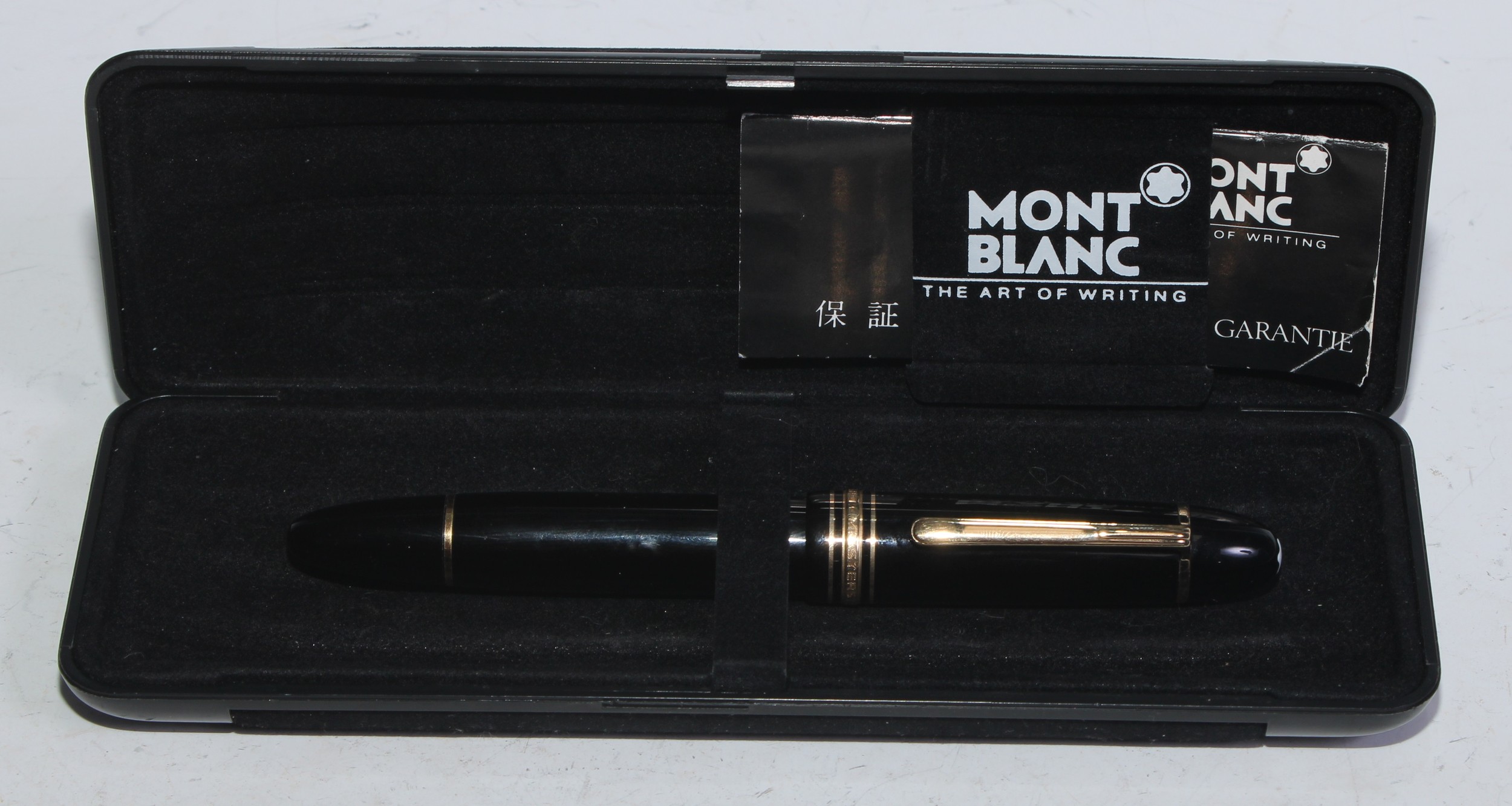 A Mont Blanc Meisterstück fountain pen, rhodium-coated 14ct gold medium nib, black resin screw-fitting cover and barrel, 15cm long, cased