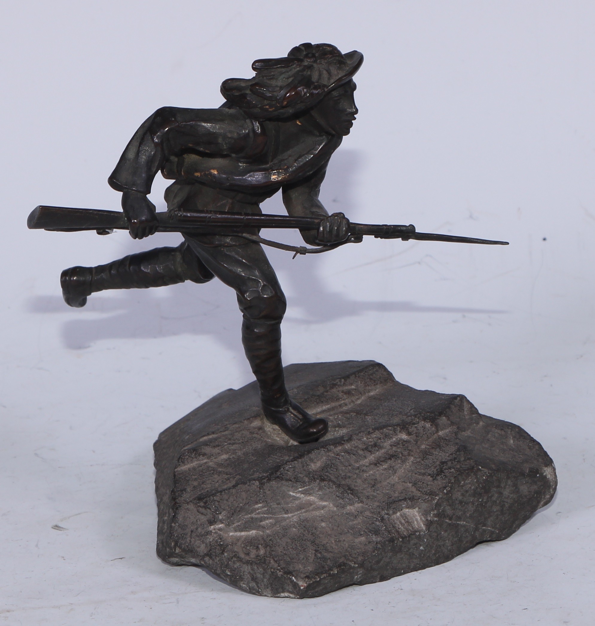 Continental School (early 20th century), a dark patinated bronze, of a World War I Italian soldier, Charging into No-Man's Land, rocky base, 15cm high