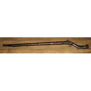 A Middle Eastern percussion jezail, 11.5cm barrel, East India Company lock, the stock applied with brass and profusely inlaid with mother of pearl, steel ramrod, 147cm long, Afghanistan, 19th century