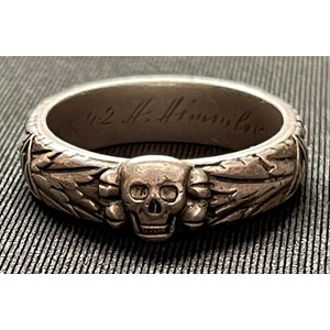 SS Ehrenring or SS Honour Ring. The ring is a very large size and measures a UK ring size Z plus 3. Width of the band is 7mm while thickness of the band is 2mm. Weight 14 grams. Made of Silver. The ring conforms to the pattern issued after 1941 with a thicker band and larger skull. The ring is correctly inscribed inside the band “To Dear” along with the award date for the Summer Solstice and officers name “Noelte” together with Himmler’s name. The full inscription reading: “Slb. Noelte 21.6.42 H. Himmler”. The ring displays the correct features which are expected to be found on an original Third Reich era example which are a soldered seamed joint to the band, which is behind the skull, a separate soldered on cast skull, along with known die flaws to the Runic panels and Oakleaves on the exterior of the band. These die flaws are only seen on original examples produced by the jeweller Otto Gahr of Munich who was the sole manufacturer of these rings. The ring exhibits very light wear both to the exterior and interior.  Original owners’ details: Born in Berlin on 4th October 1916. Served as a Staff Officer in the Heer in the 4th Panzer Division. Transferred to the Waffen SS in 1944 with the rank of SS Hauptsturmfuhrer serving with the 10th SS Panzer Division “Frundsburg”. Final rank of SS Sturmbannfuhrer. SS Number 160897. NSDAP Party number 3,474794. Taken Prisoner of War and interned in Sandbostel Camp and released on 4/9/1946. Died in 1961. Comes with research and a Don Boyle Certificate of Authenticity and another from Craig Gottlieb.
