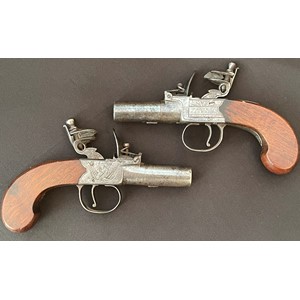 A matched pair of Flintlock Pocket Pistols by "Mabson & Labron". Both with with 55mm long screw on barrel. Bore approx. 12mm. Working A matched pair of Flintlock Pocket Pistols by "Mabson & Labron". Both wiaction which holds at both half and fully cocked positions. English proof marked. Maker marked to lock plate "Mabson & Labron" along with engraved piled arms motif. The maker was located in Birmingham and was in business under this trade name from 1822 until 1834.  Walnut grips. Overall length 150mm. Section 58 (2) no licence required. (2)