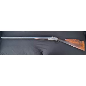 Rosson & Son 12 Bore Side by Side Shotgun serial number 29262. 712mm long barrels. Receiver and fore end have matching numbers. Barrel is not matching and is numbered 25145, no maker mark. 2 1/2 inch chambers. Double trigger. Gun number "1" on forend and on top lever. Formerly one of a pair. Gilt Cartouche on underside of butt. Stock has had alterations to comb and butt. Overall length 117.5cm. NOTE: Buyer must hold a valid Shotgun Certificate or be a Registered Firearms Dealer.