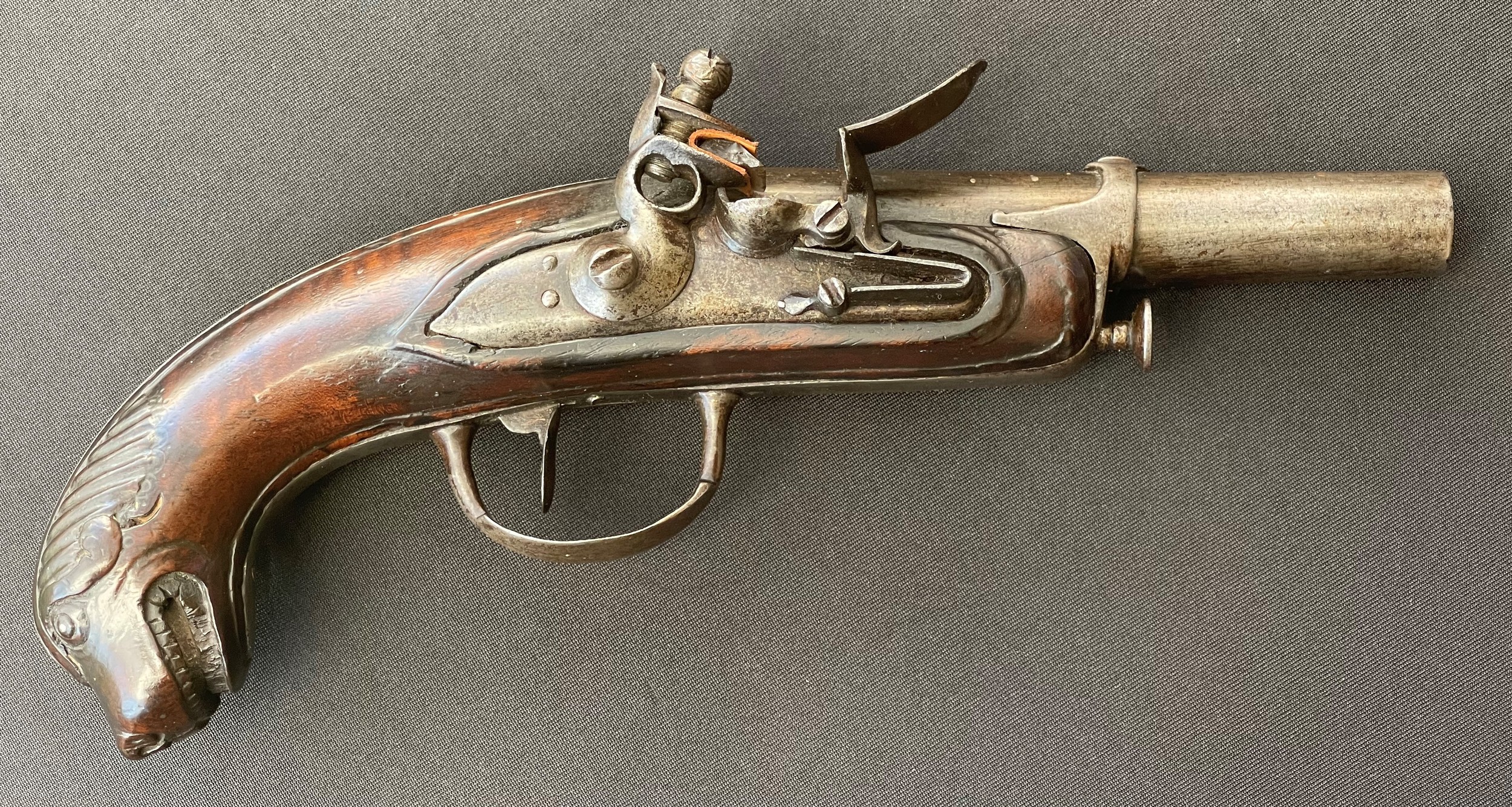 French 'Chien de Mer' naval officer's flintlock pistol with 110mm long barrel. Bore approx. 15mm. Working action which holds at both full and half cocked positions. No makers marks or Proof marks. Overall length 225mm. Carved decoration of a Dogs head to the butt. Complete with a steel ramrod. Section 58 (2) no licence required.