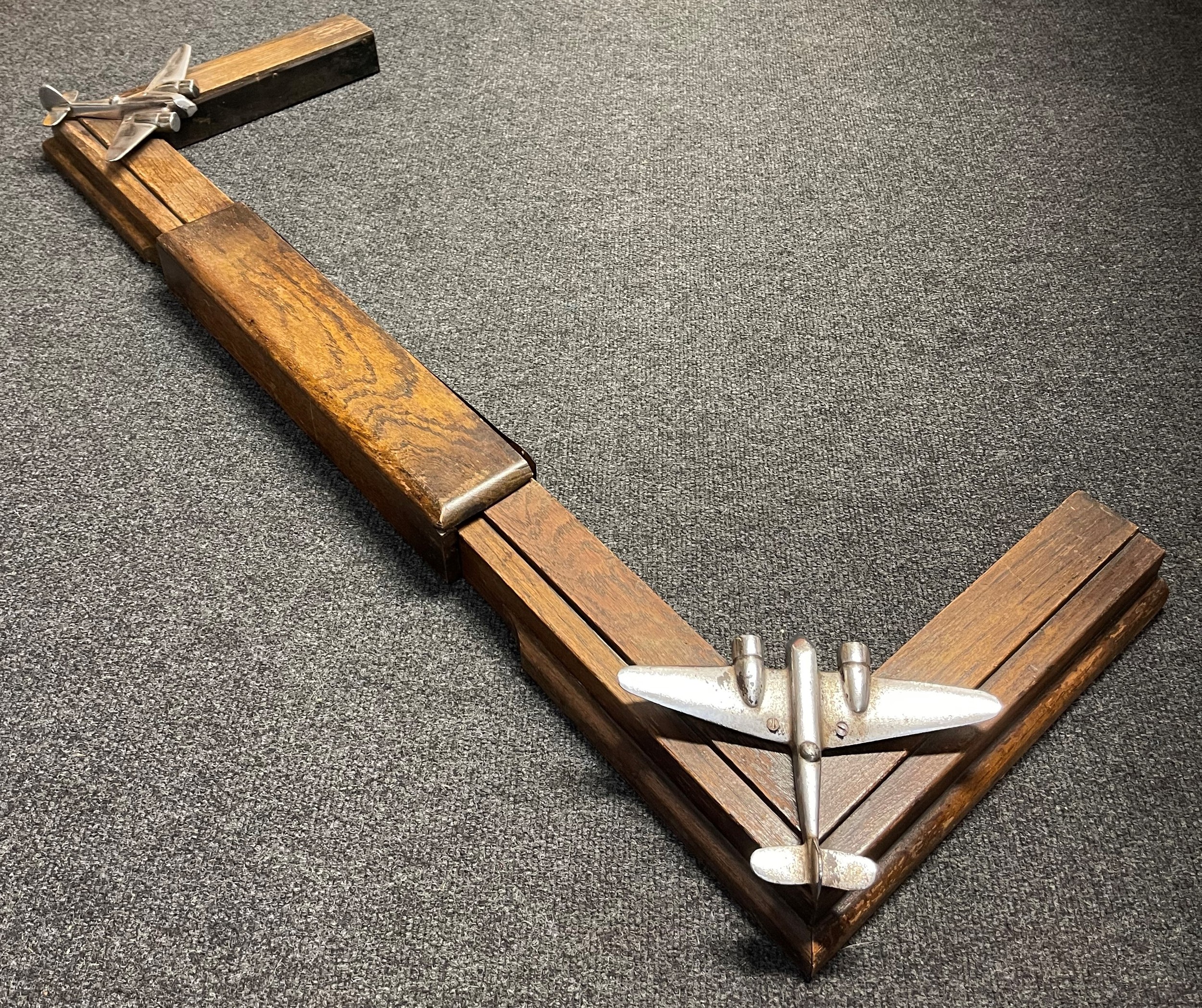 WW2 British RAF Sgt's or Officers Mess Fireplace Surround. The surround is adjustable to fit different size fireplaces from 88.5cm to 112.5 cm internal dimensions. Internal depth 27.5cm. At each corner is fitted a chrome plated model of a Blenheim Bomber, size 22cm wingspan. No makers markings.