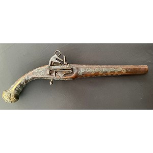 Balkan style Flintlock Pistol with 270mm long barrel. Approx. 13mm Bore. Working action. Decorated stock inlaid with scrolls of silver overall. Cast decorative brass butt plate. Jaws also inlaid with silver wire. Overall length 460mm. No makers marks or proof marks. Section 58 (2) no licence required.