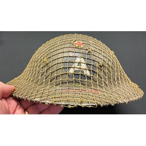 WW2 Rare British Home Front Steel Helmet for the Peak District Ambulance Service. Insignia to the front of the helmet is a mixture of hand painted Red Cross, "A" for Ambulance, red PDAS, green letter "S" along with a decal for the wording "Ambulance Service". The helmet is covered with it's original camo netting cover. To the inside is a panel painted in grey with the owners initials "FS" painted in black. The chinstrap has two period repairs done in canvas cloth. This helmet is new to the market never having been in a collection before. It is being sold by the family of the original owner. Also included is an original photo of the owner, Mr Fred Stansfield and two showing the unit's ambulances.