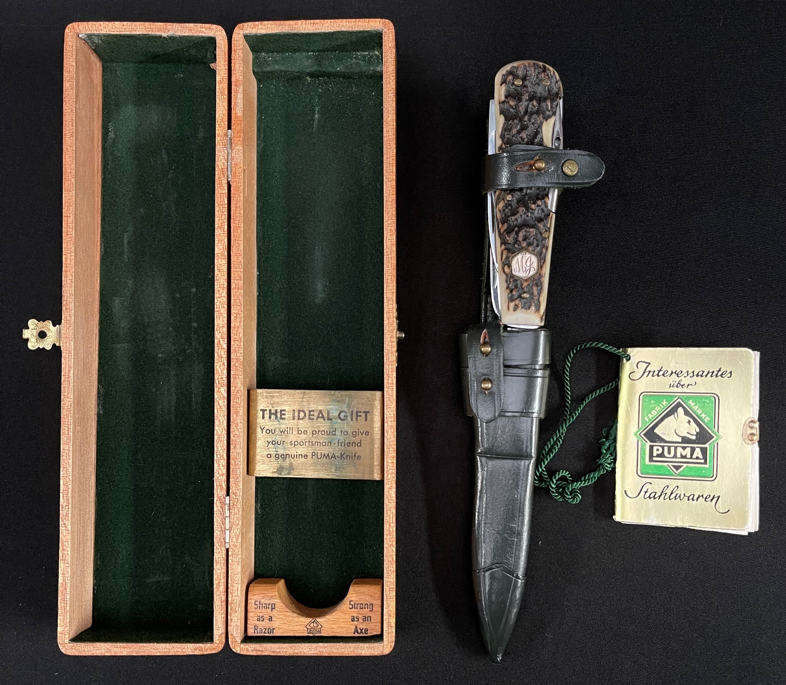 Puma of Solingen Gamekeepers Knife Model No.3591. Handmade Multi blade knife with large single edged blade 110mm in length, blade is marked "Original Waidmesser fur Schalenwild" on one side along with "Puma-Werk, Solingen. Made in Germany. Handarbeit. Bestell-No. 3591". Antler grips which contain a skinning blade 64mm in length, saw blade with bottle opener and screwdriver point 75mm in length, plus a 45mm long spike blade with eye. Grip inset with .800 silver marked escutcheon plate engraved "MJ". Contained in a green leather sheath with belt loop. Come in it's original wooden display box with original paper instruction leaflet.