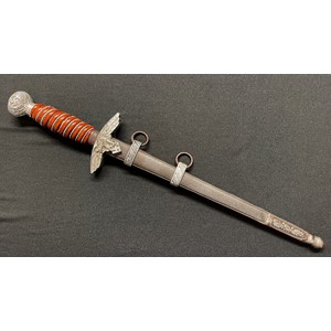 WW2 Third Reich Luftwaffe Dagger with double edged blade 255mm in length maker marked "SMF, Solingen". Also Luftwaffe Proof mark Eagle 5 to blade. Orange grip with partial grip wire present. Overall length 385mm. Complete with steel scabbard with alloy fittings.