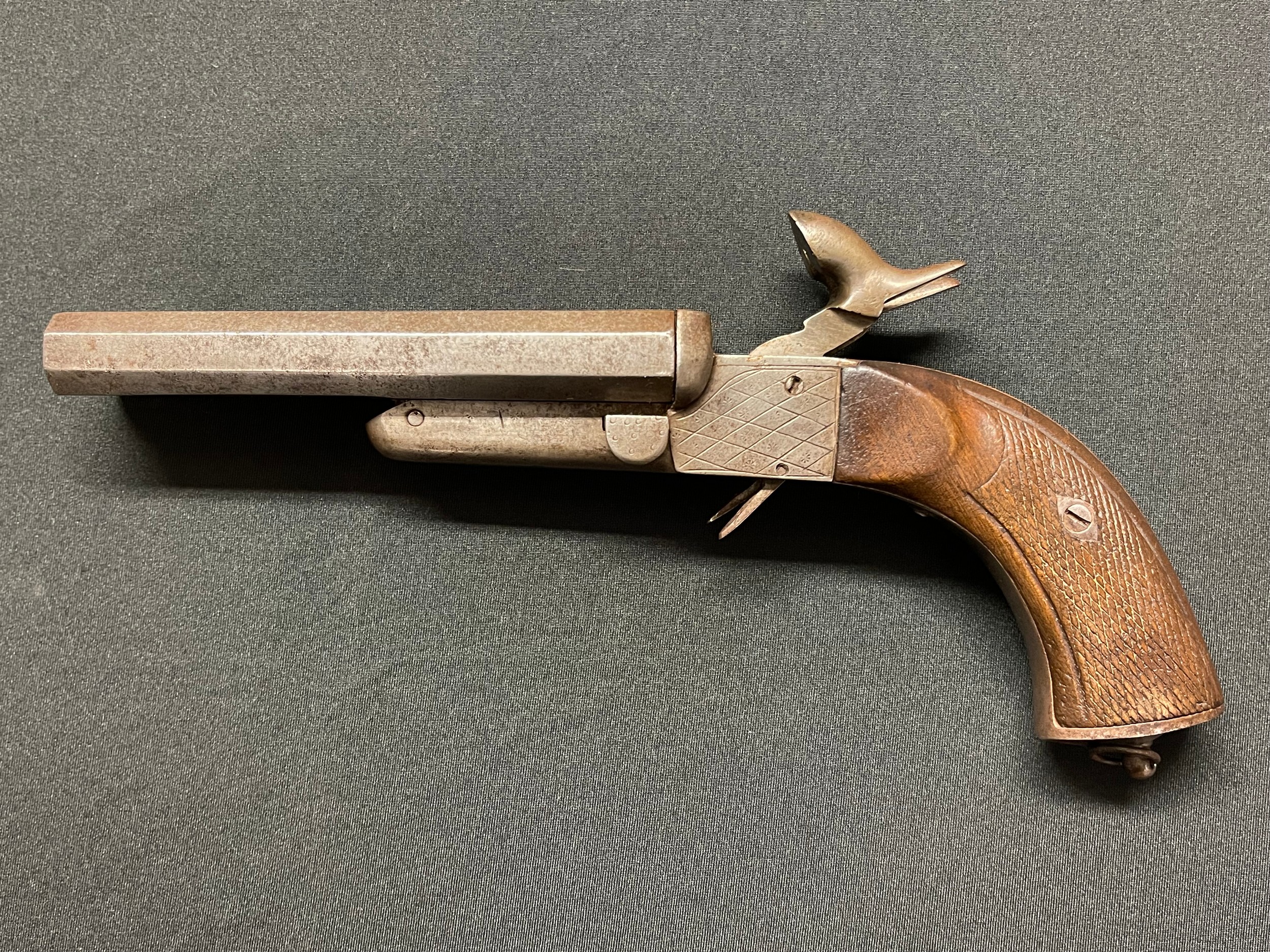 Double barrel pinfire pistol with 139mm long barrels. Bores approx. 14mm. Working condition. No makers marks. Barrels and receiver  both stamped "22". Receiver also marked "1850". Lanyard ring to butt. Overall length 260mm. Section 58 (2) no licence required.Folding triggers.