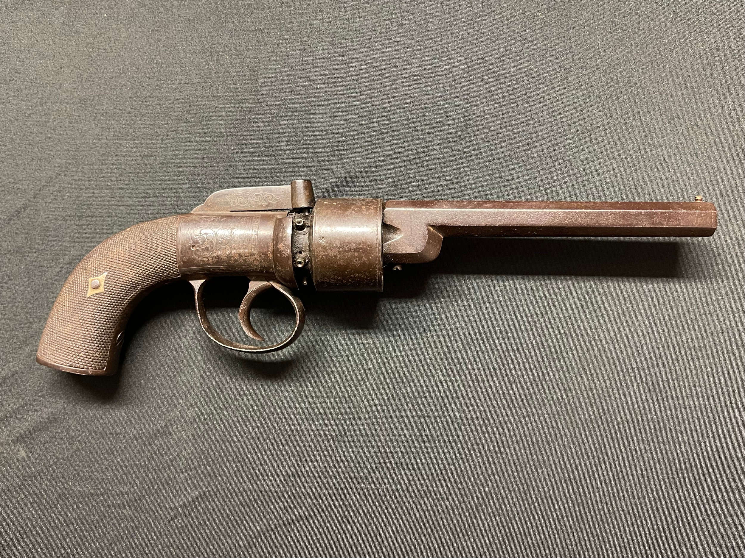 Percussion Cap Revolver with 143mm long barrel. 6 shot cylinder. Bore approx. 9mm. No makers marks. English Proof marks. Double action, working condition. Engraved decoration to receiver, hammer and butt. Overall length 300mm. Section 58 (2) no licence required.