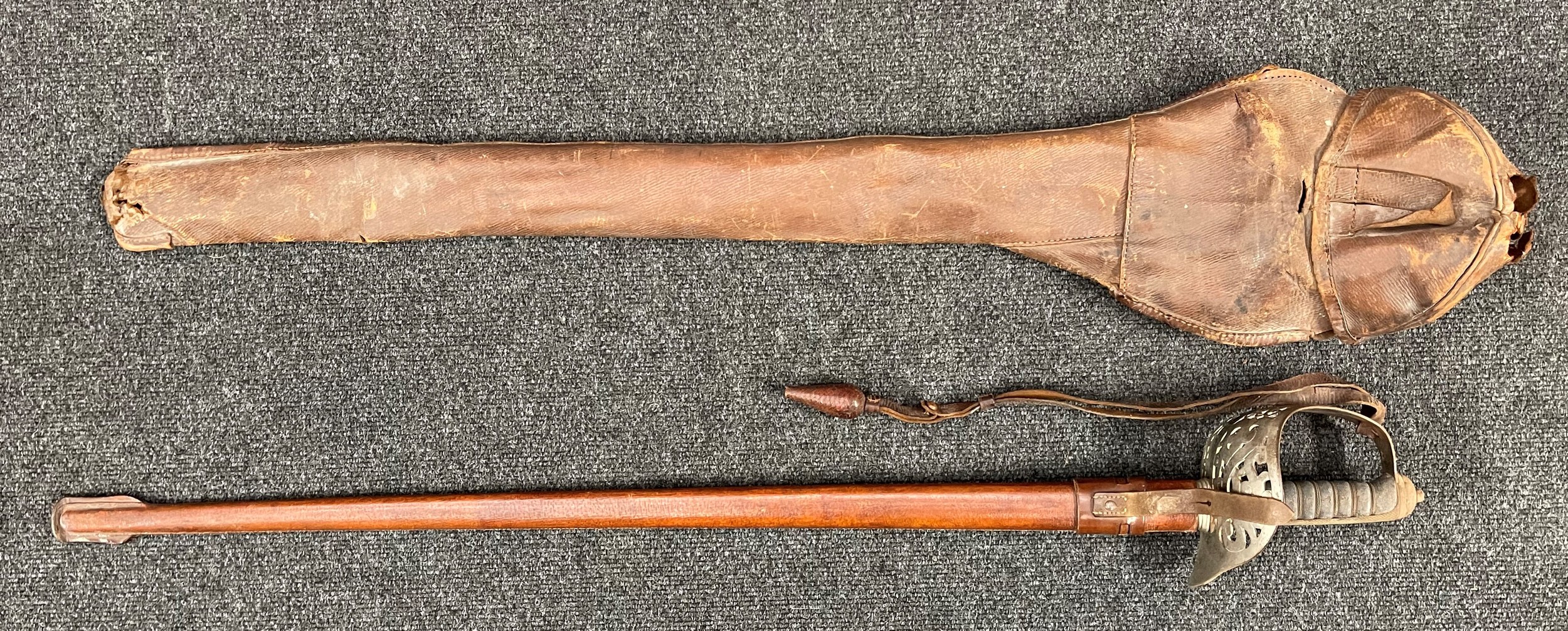 WW2 British 1897 Pattern Officers Sword. 815mm long single edged fullered blade with etched decoration. Proof marked. Numbered to spine of blade "100256". Retailer marked "Hobson & sons, 1, 3 &5 Lexington Street, Golden Square, London W". VR to blade and also VR marked to Guard. Shagreen wire bound grip. Overall length 975mm. Complete with leather knot, leather covered scabbard and leather cover, marked "RAMC" and "RVF. This sword was carried by Col. Robert Vincent Franklin, OBE, RAMC. The family believe it was later carried in WW2 by his son, William Franklin RAMC. He saw service in the Far East. New to the market.