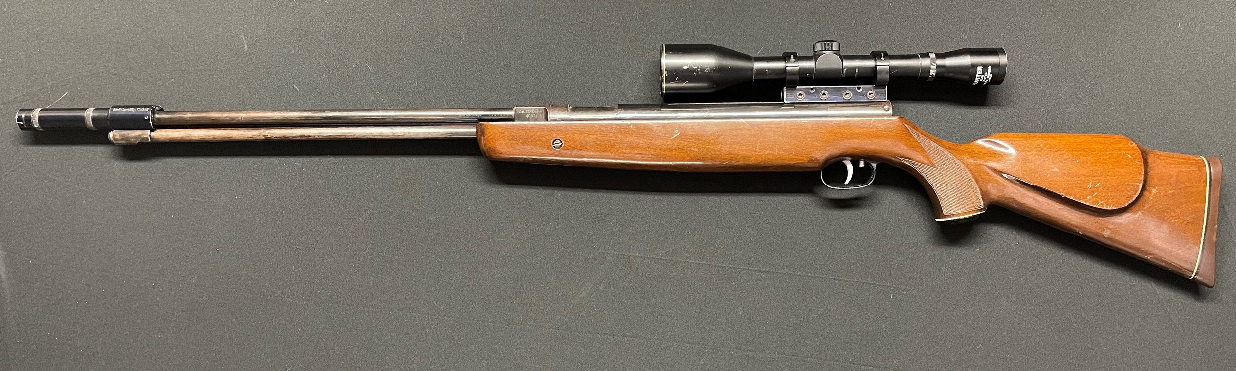 Weihrauch HW77 .22 cal Under Lever Air Rifle serial number 1180853. Barrel stamped "Hull Cartridge" and fitted with a Hull Cartridge Co Ltd Moderator. Barrel length 460mm. Fitted with a Hunter 6 x 45 Telescopic Sight. Overall length inc Moderator 121cm. Working order.