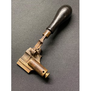 A 19th century patent James Dixon & Son #1182 ball cartridge creaser, Cal. 577. Brass body, colour hardened steel lever, turned ebony handle.