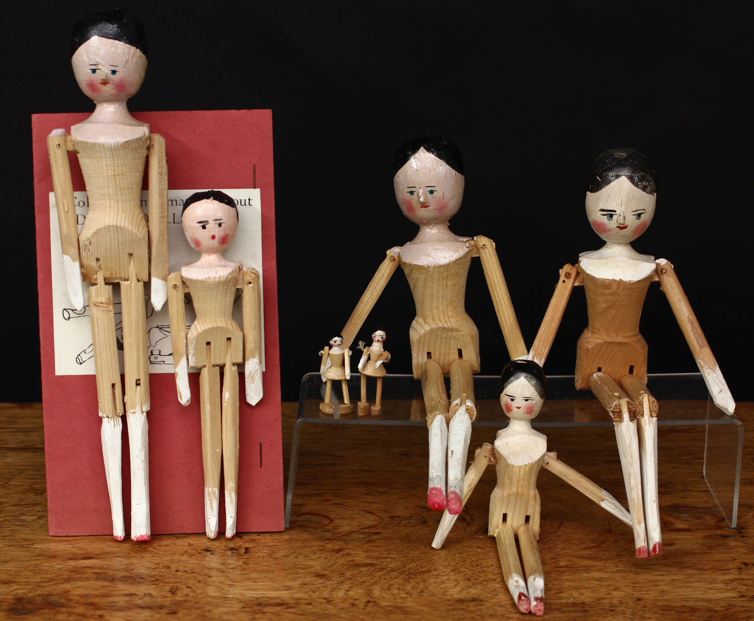 A collection of novelty wooden peg dolls/Dutch dolls or Grödner Gliederpuppen, various sizes ranging from 4cm high to 25cm high; a folded leaflet, titled ‘Collected information about “Dutch Dolls”, dated January 1961 (8)